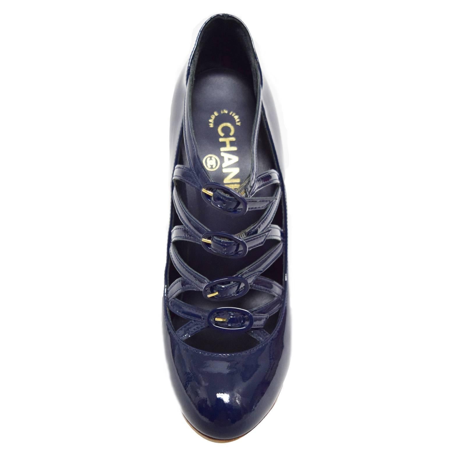 These Chanel classics are a navy patent leather pump with a buckle embellished  upper. The heel of the shoe has a gold waffle print wedge adding a cool sexy contrast. 