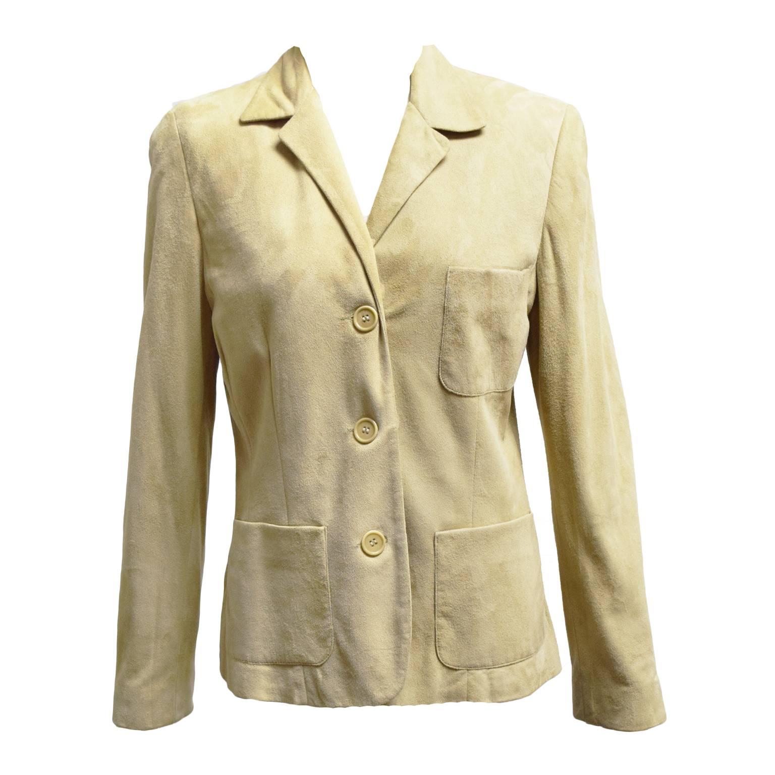 This Ralph Lauren two piece skirt suit is made out of beige brushed suede and is fully lined in silk. The skirt has a back zip and the jacket has frontal pockets and button closures. Great for a fall look. 