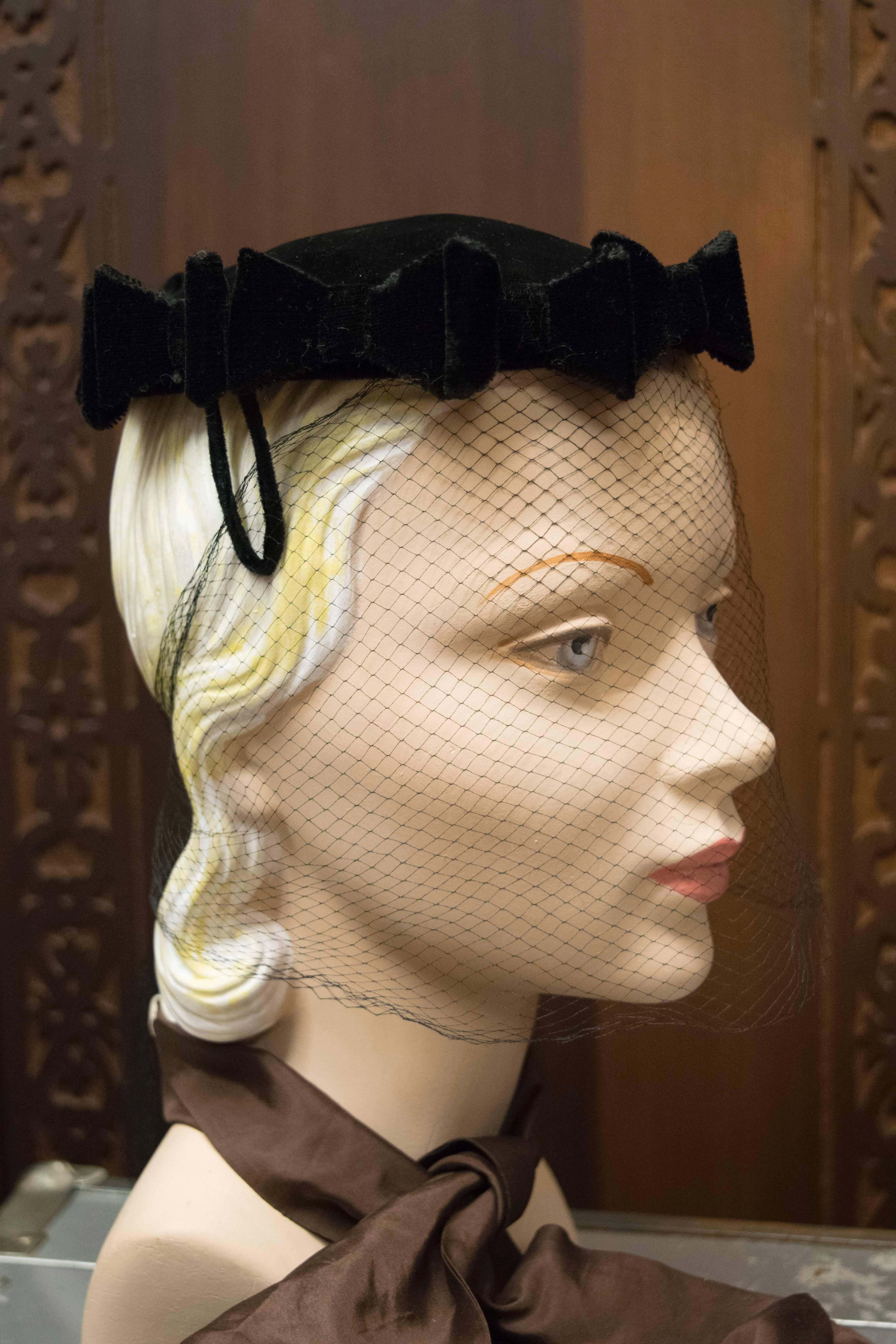 1950s Cocktail Hat with Veil

Wonderful black silk velvet hat with bow detailing and original netting in excellent condition 