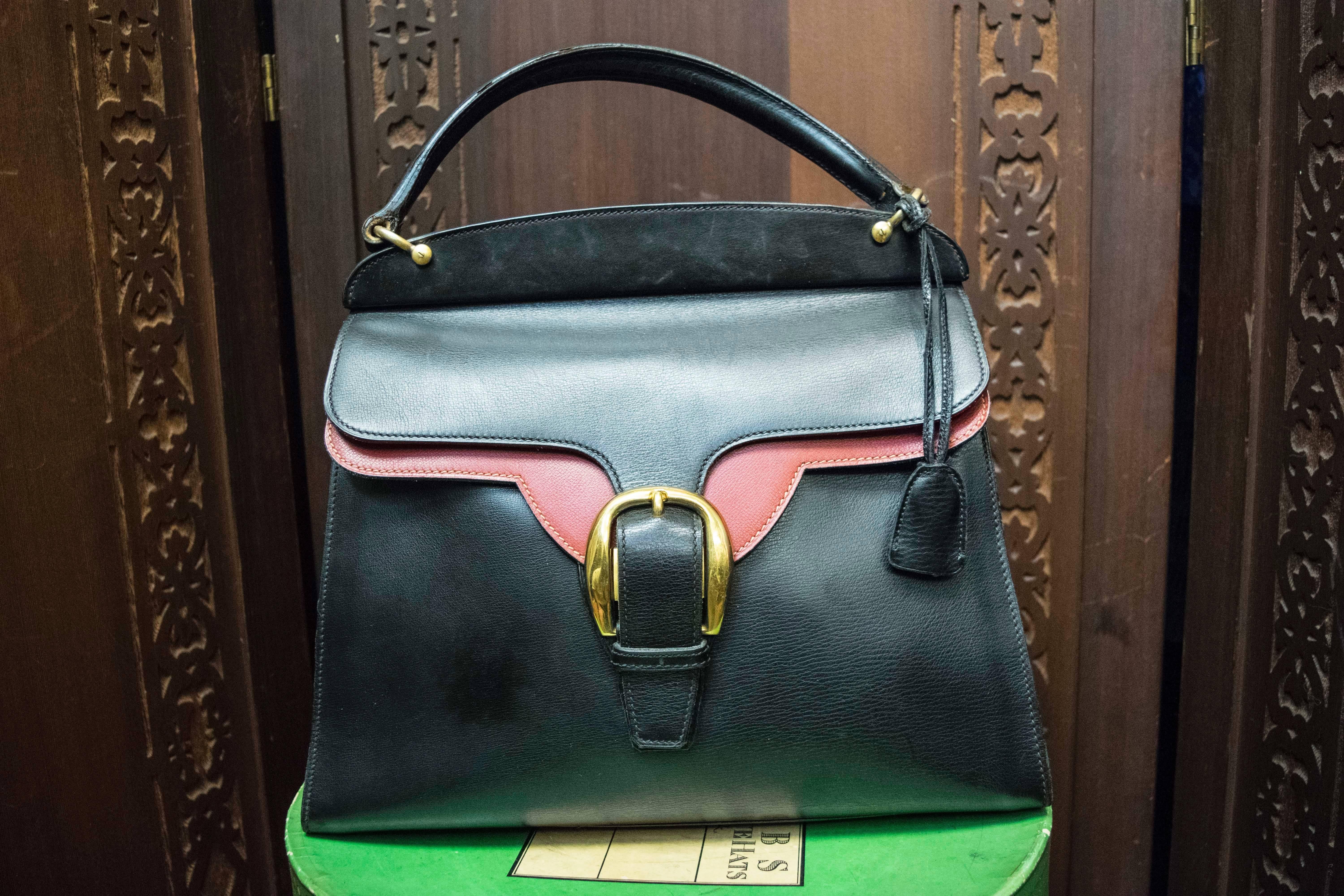 1950s Gucci Black and Red Leather Handbag 

Stunning Gucci handbag in excellent condition with the original key and lock. The leather is in near perfect condition and considering its age this is a truly rare find.  

L 14
H 11
D 5