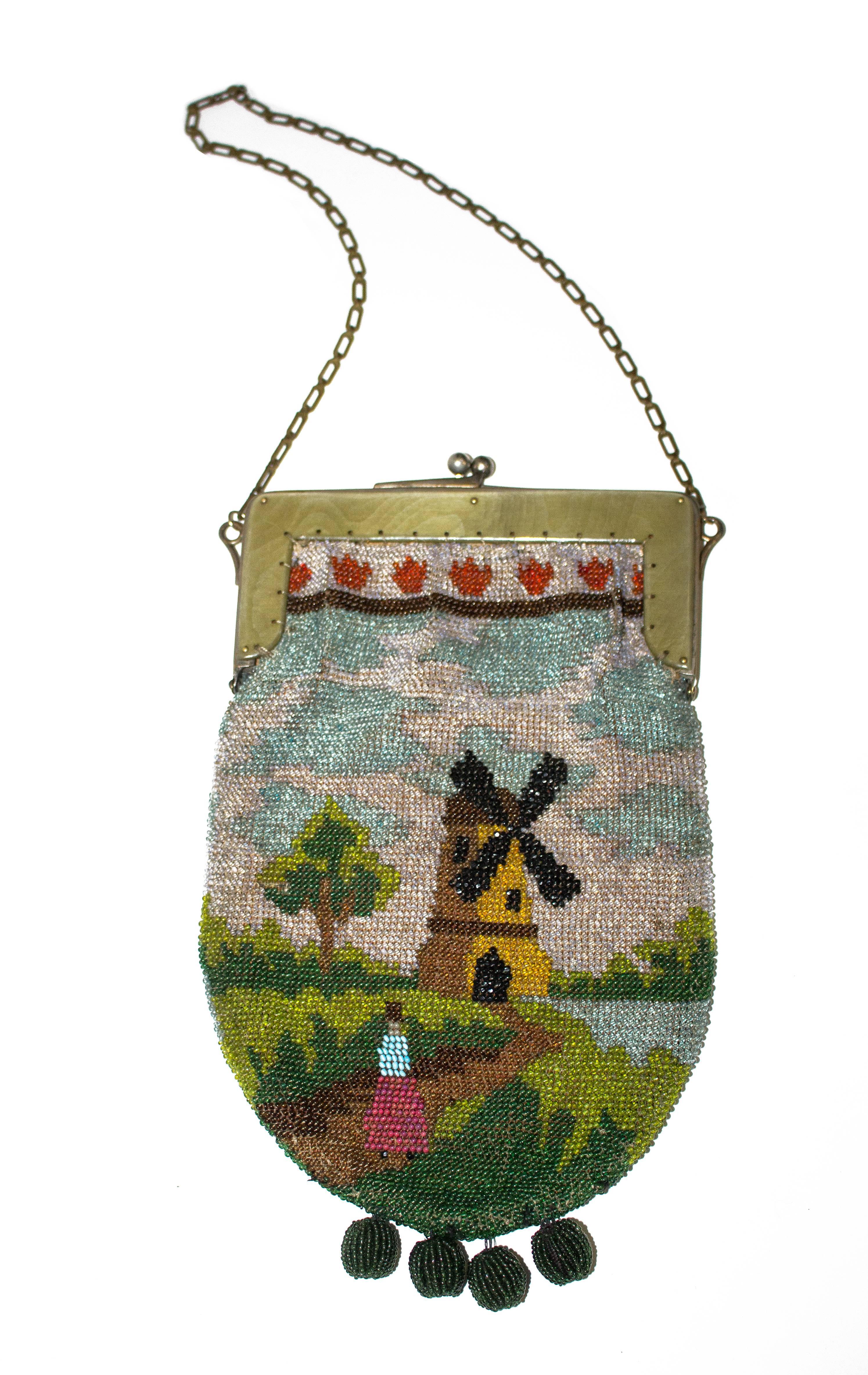 1920s beaded scenic purse. Resin faux-wood hardware. Chain handle. 

Handle height: 9"
Purse height: 9 1/2"
Purse width (at hardware): 6"