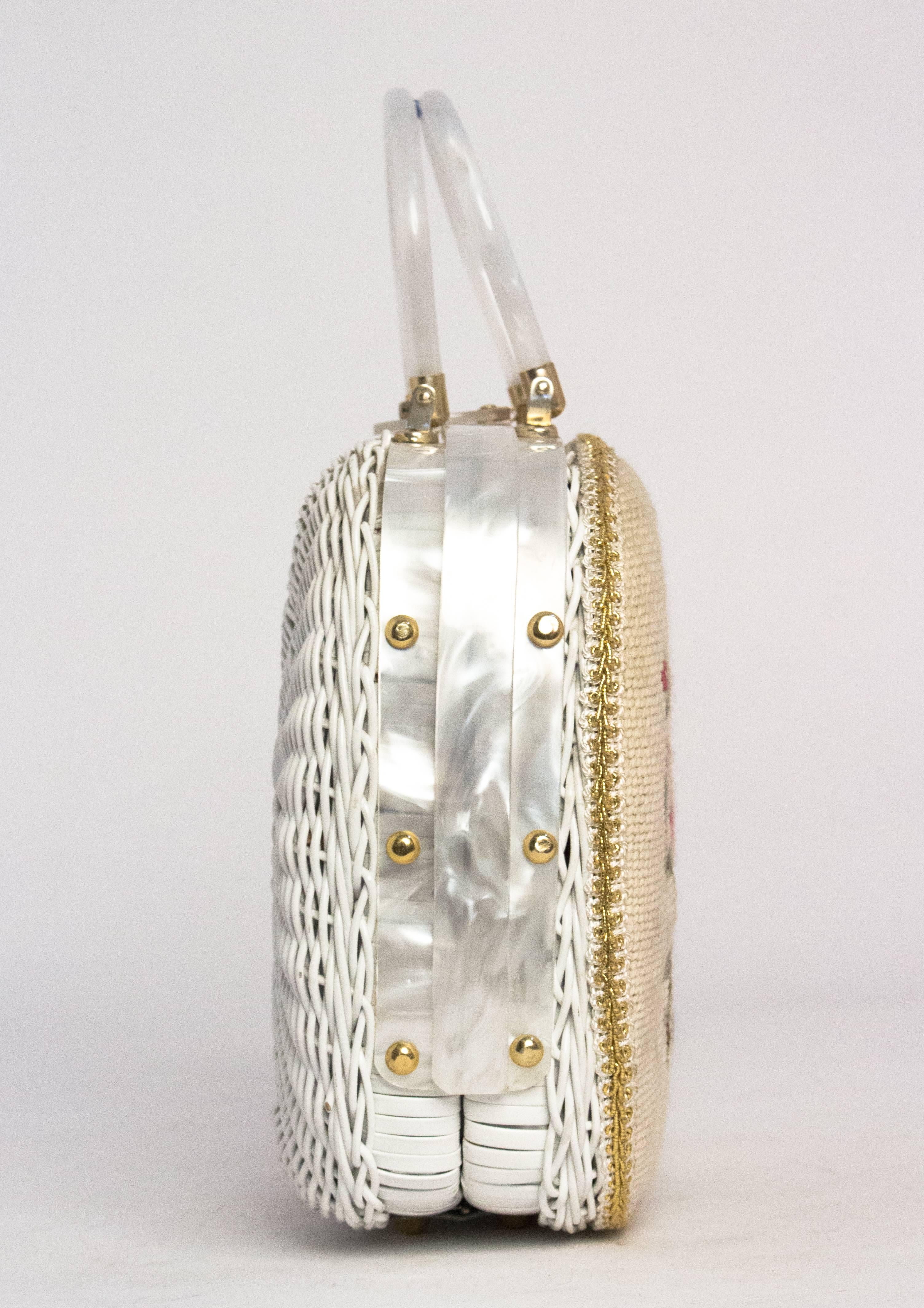 60s Floral Needle Point Lucite Handbag with woven frame. Gold tone hardware. Two interior compartments, one is closed with a metal zipper. Plastic lining. 

Measurements:

Width: 11.5