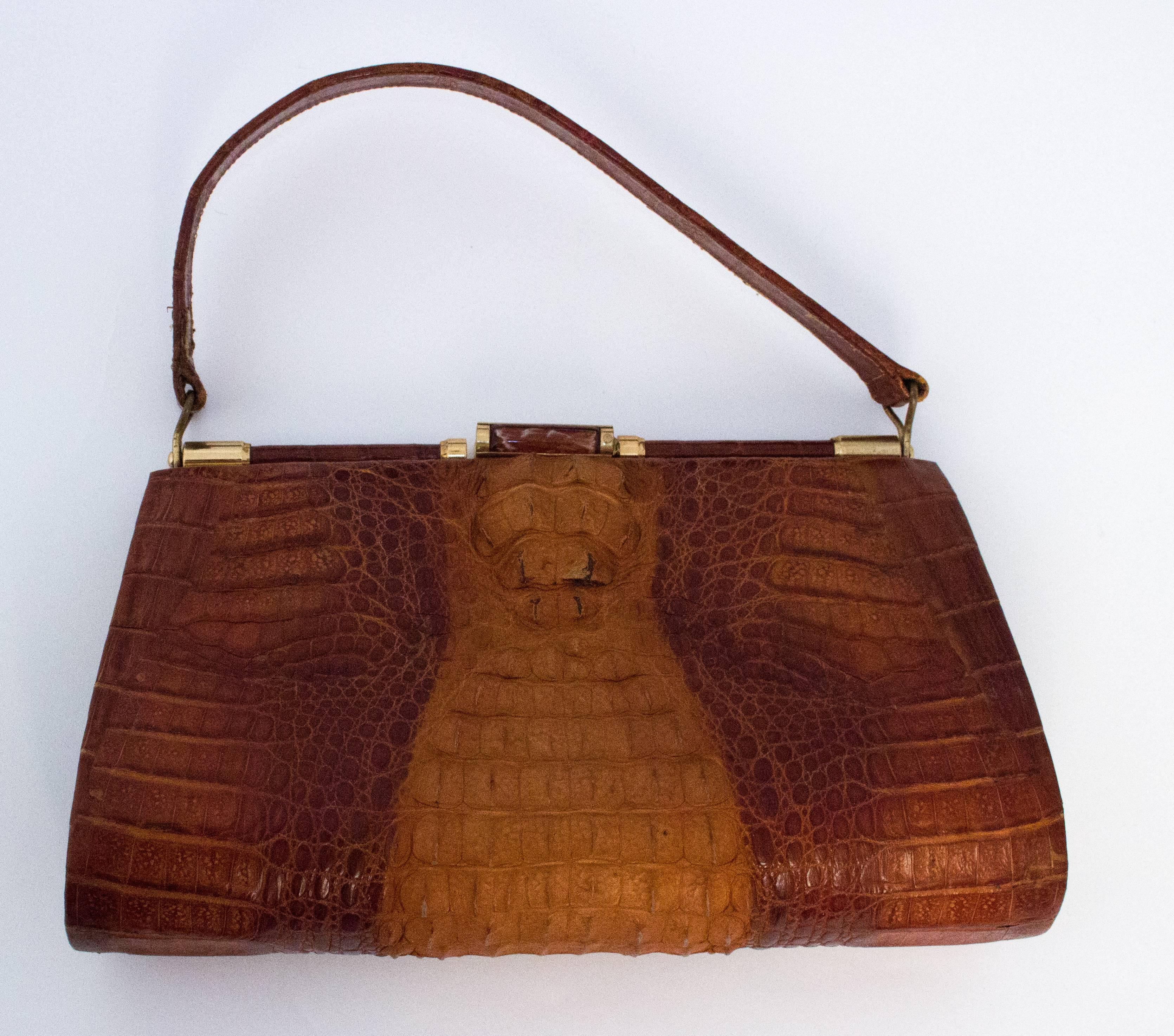 50s Hornback Alligator Handbag. Gold toned hardware. Three interior compartments, one with a zipper. 

Measurements: 

Width: 9