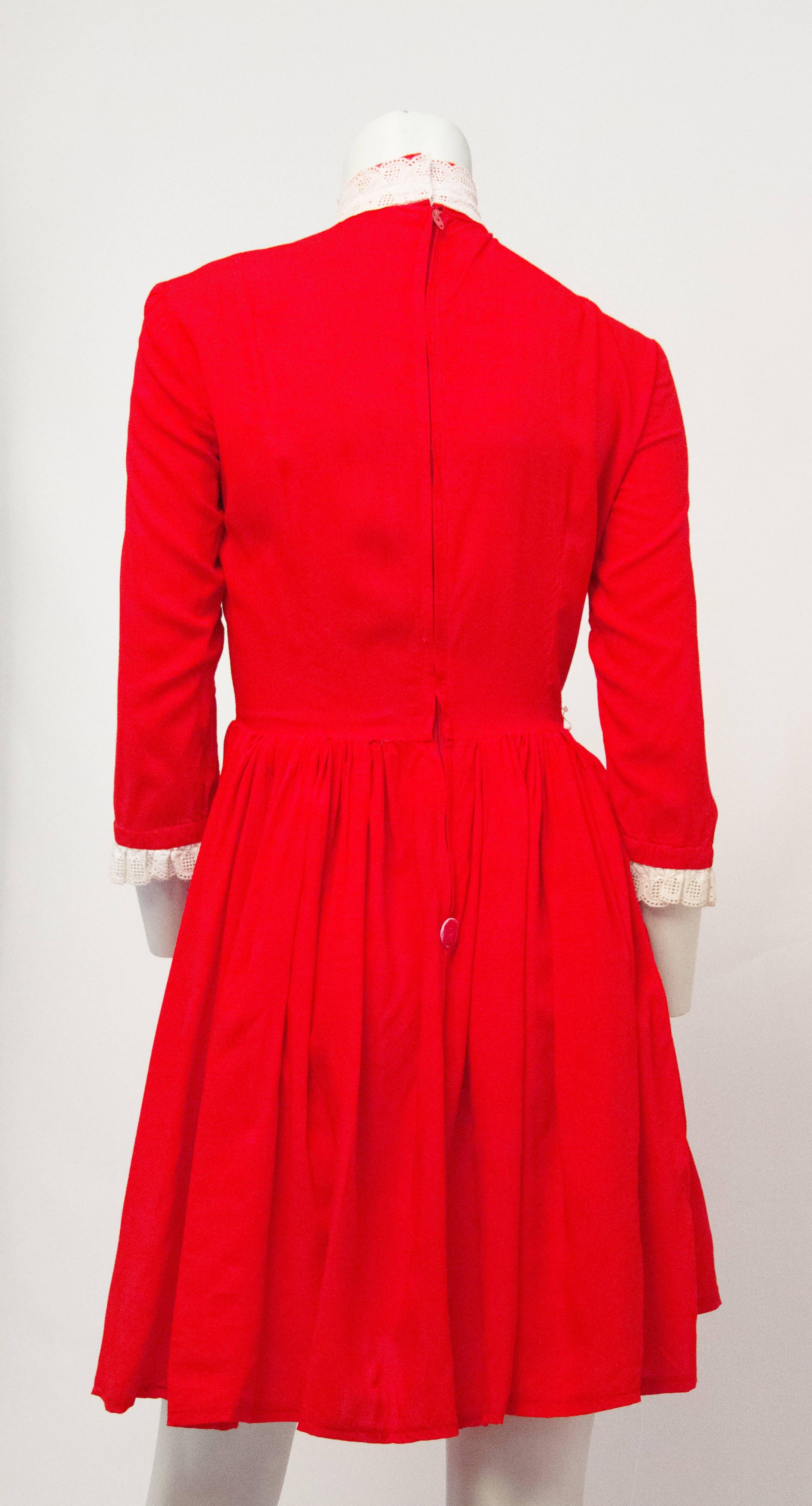 60s red princess seam babydoll dress with white eyelet trim on collar and cuffs. Nylon zipper up the back. 