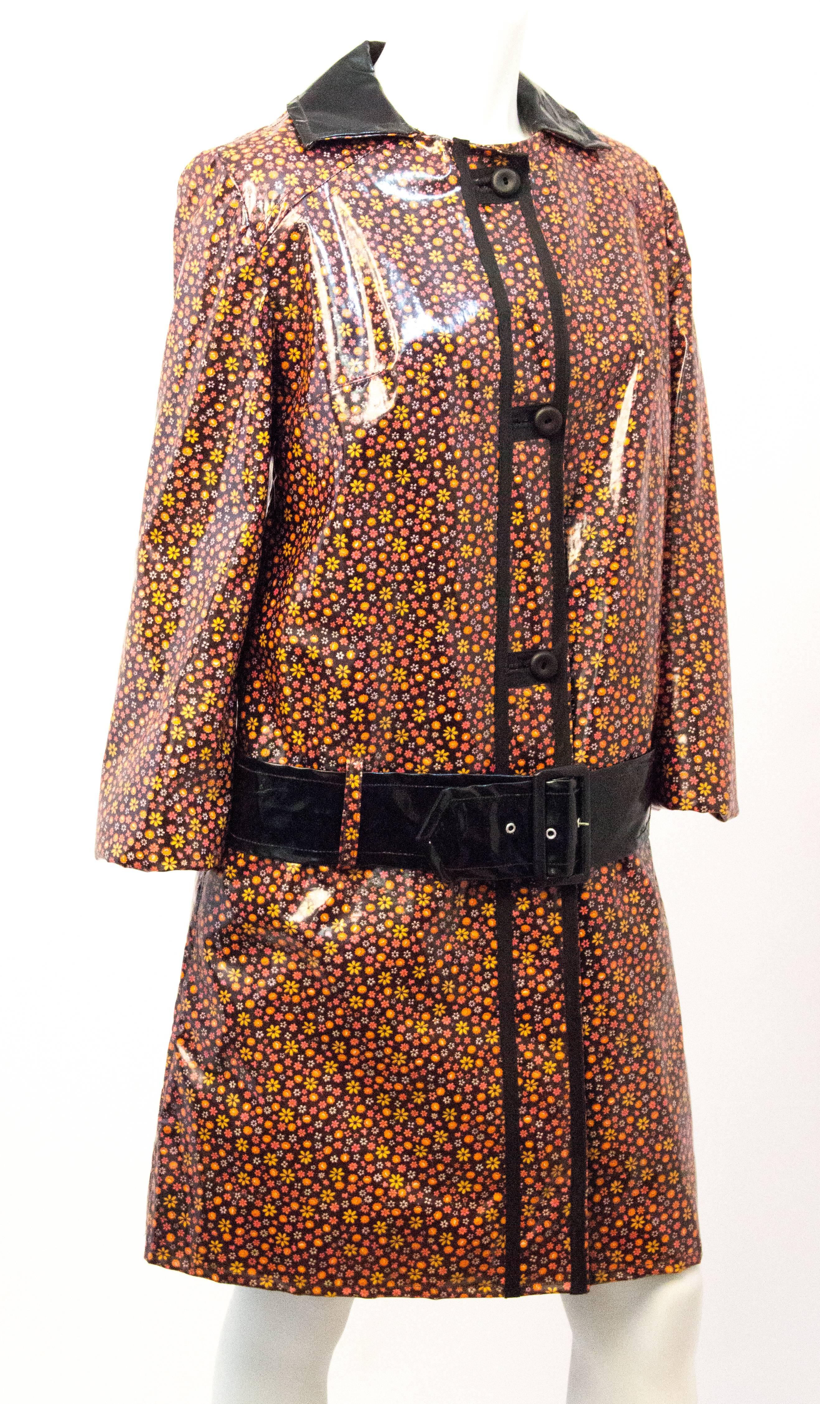 Custom made printed vinyl mod raincoat completely lined and includes drop waist belt. One of a kind made by a young fashion designer in the 1960s. 