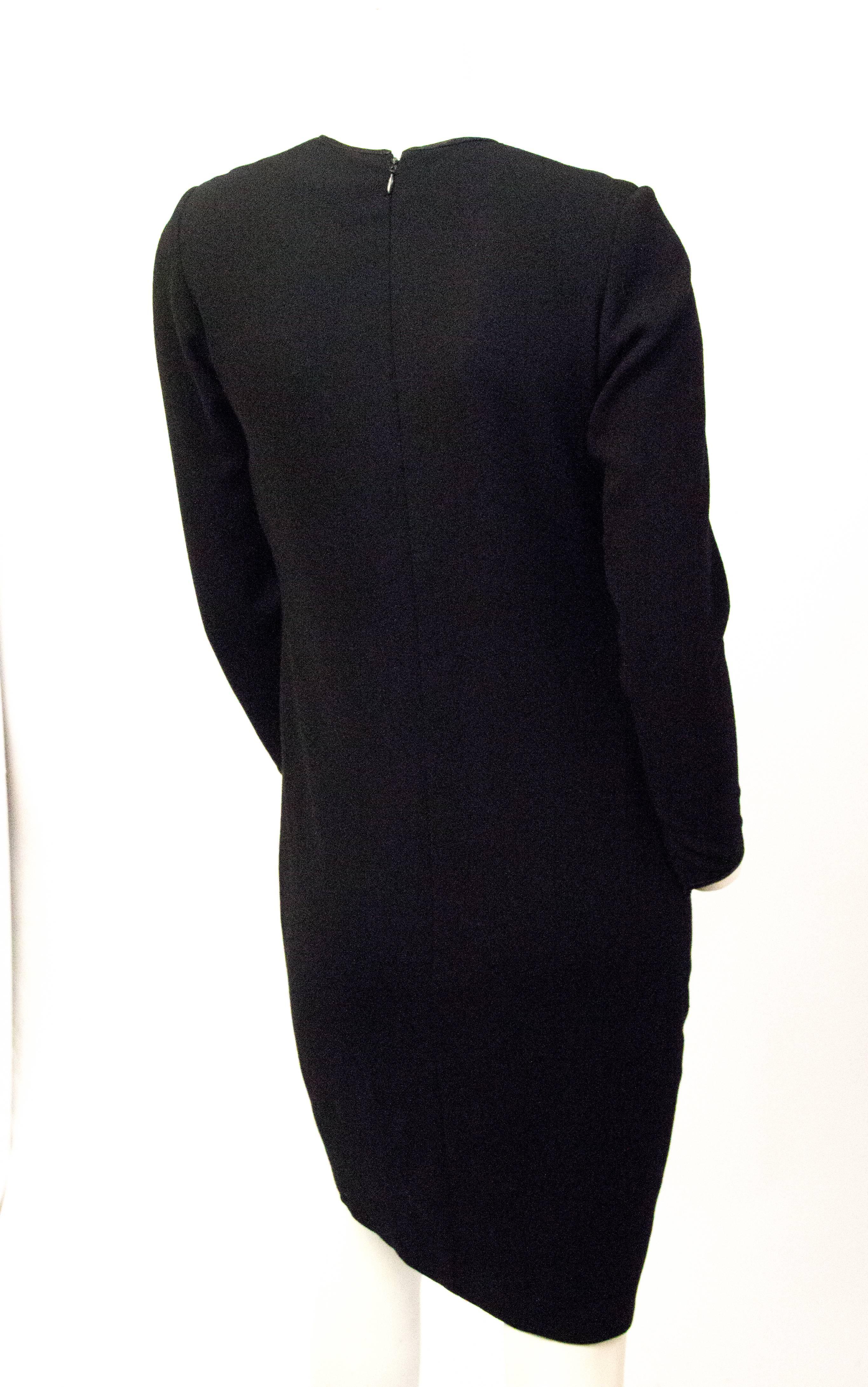 80s Galanos black crepe sheath with long sleeves that zip at the wrist. Black silk  insert in top front of bodice. Fully lined in silk chiffon. Zips up the back. 