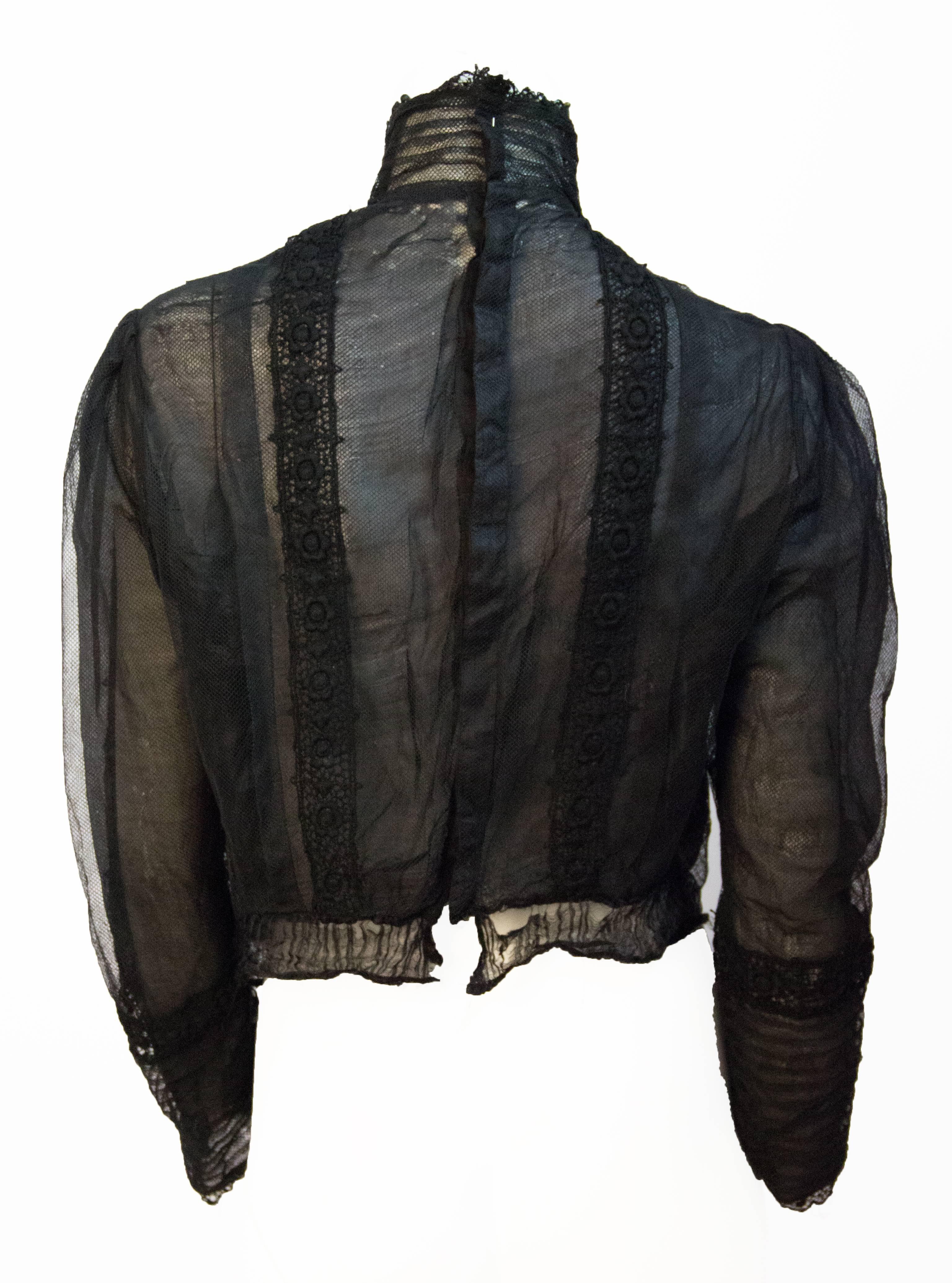 Edwardian black mesh embroidered blouse. Slight pigeon chest. Lace Trim. Black jet bead embellishments. Metal collar stays. 