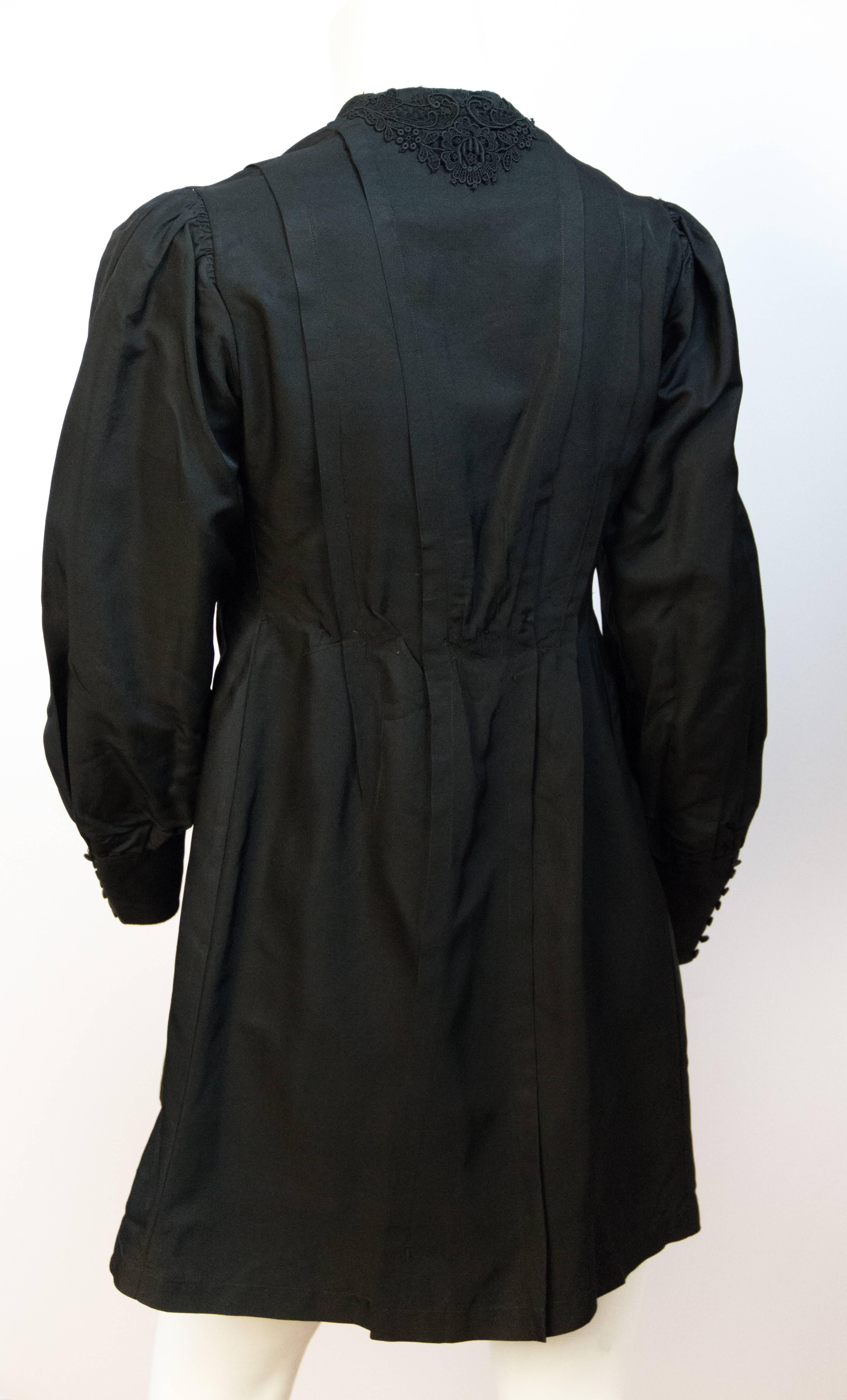 Edwardian black silk jacket with bright purple insert in bodice. Black silk covered buttons. Black silk trim throughout. Unlined