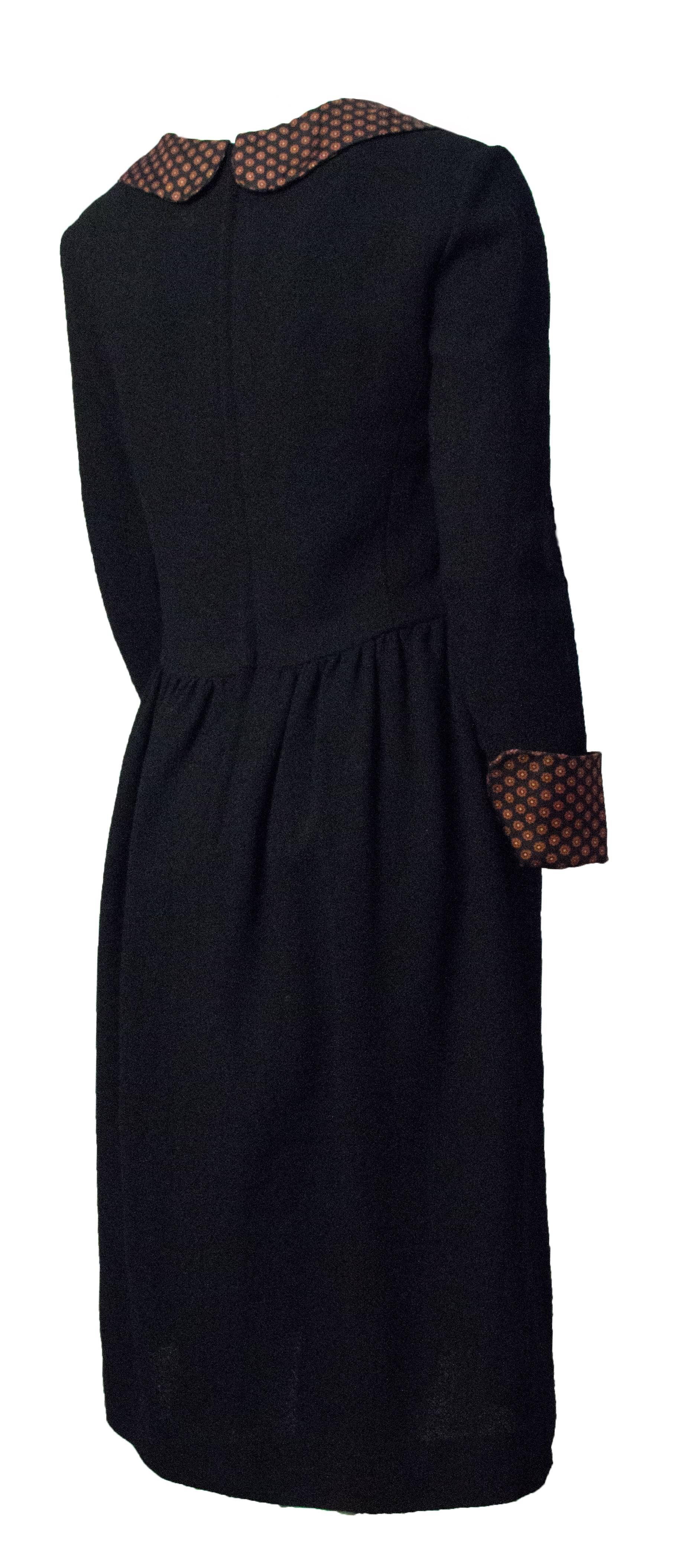 60s Mary Quant medium weight black wool blend dress. Mini floral printed silk cuffs and peter pan collar. Metal zipper up the back. Fully lined. 

 