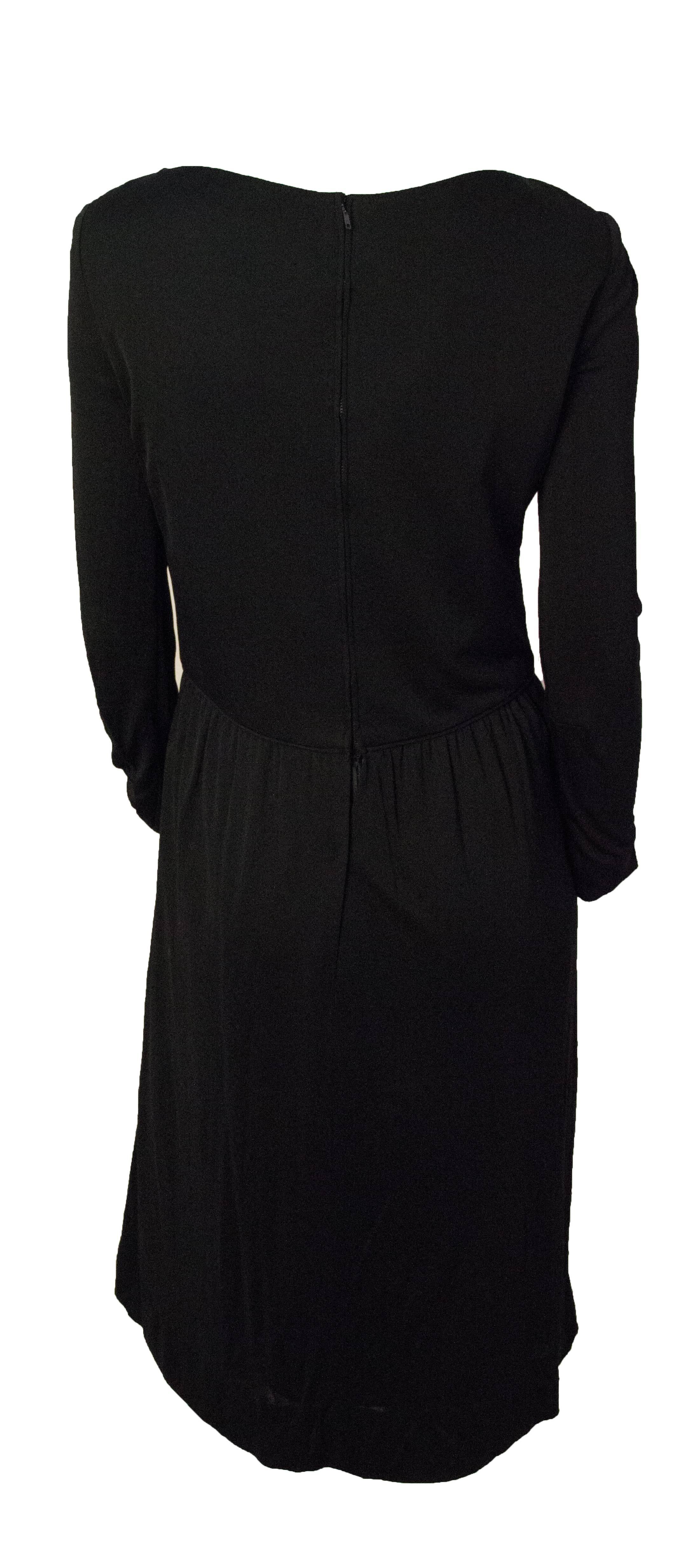 70s Ceil Chapman black silk jersey dress. Lace up front. Rhinestone encrusted grommets and end pieces on lace. Metal zip up the back. Fully lined. 