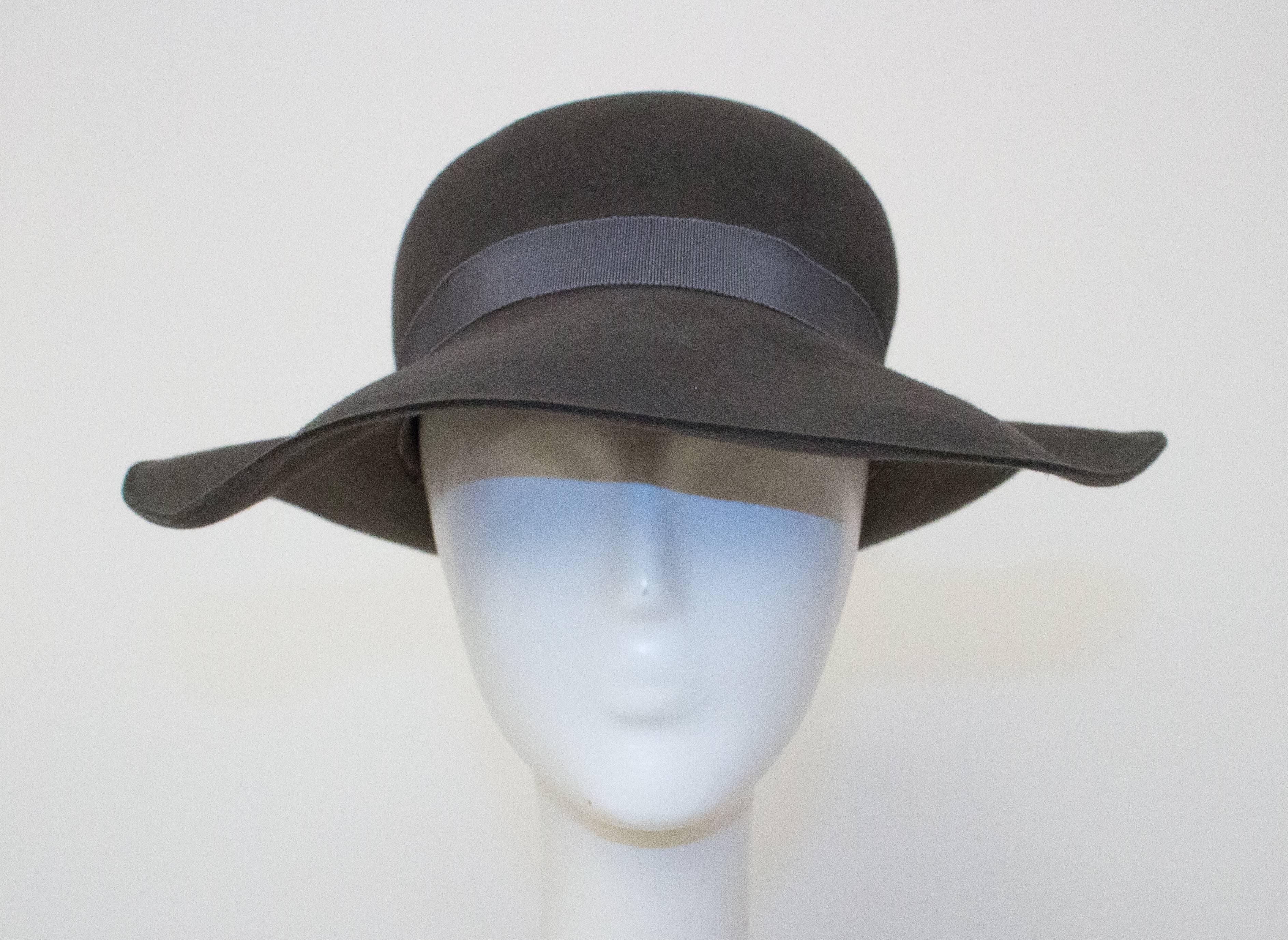 80s Giorgio Armani felt floppy hat. Extremely soft. Gros grain interior and exterior band. 

Measurements

21 1/2" circumference 
2 3/4" - 3 1/2" wide band 