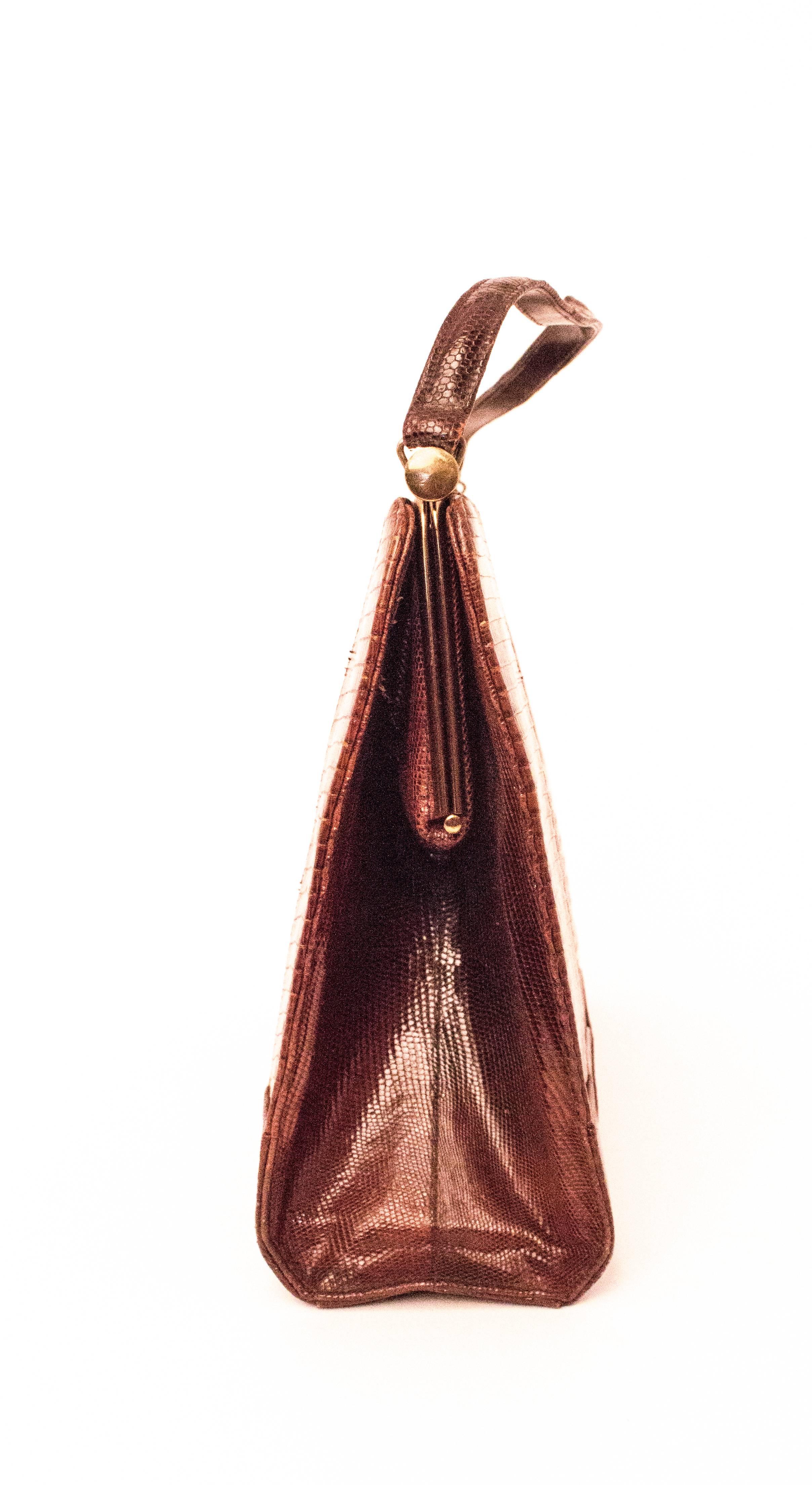 60s Brown Reptile Handbag. Gold tone hardware. Two interior compartments, one is zipped. 

Measurements:
Handle: 14 1/2"
Body of Bag: Approx. 13" x 10" 

