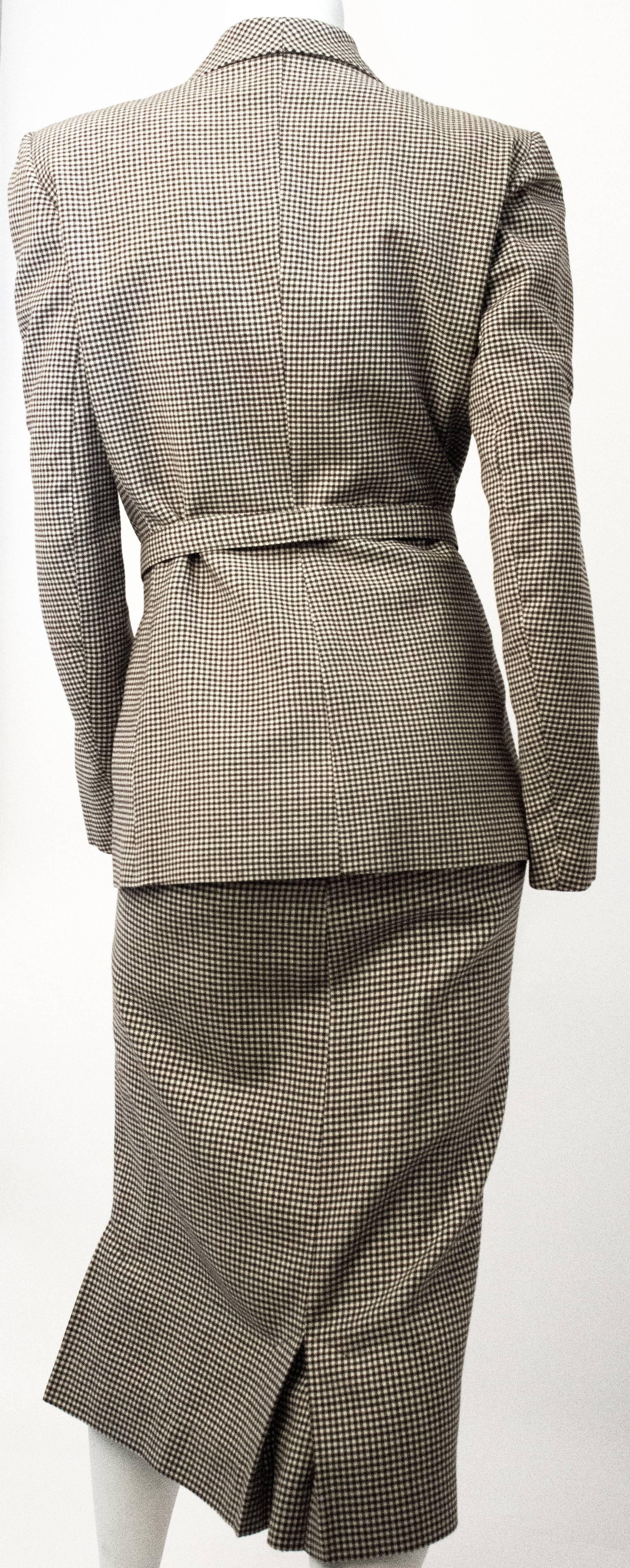 40s Joseph Magnin Brown and Cream Gingham Skirt Suit. Jacket is lined. Covered buttons secure the front. One small pocket on the right side. Original belt included. Skirt is unlined, zips up the side and has kick pleats. 