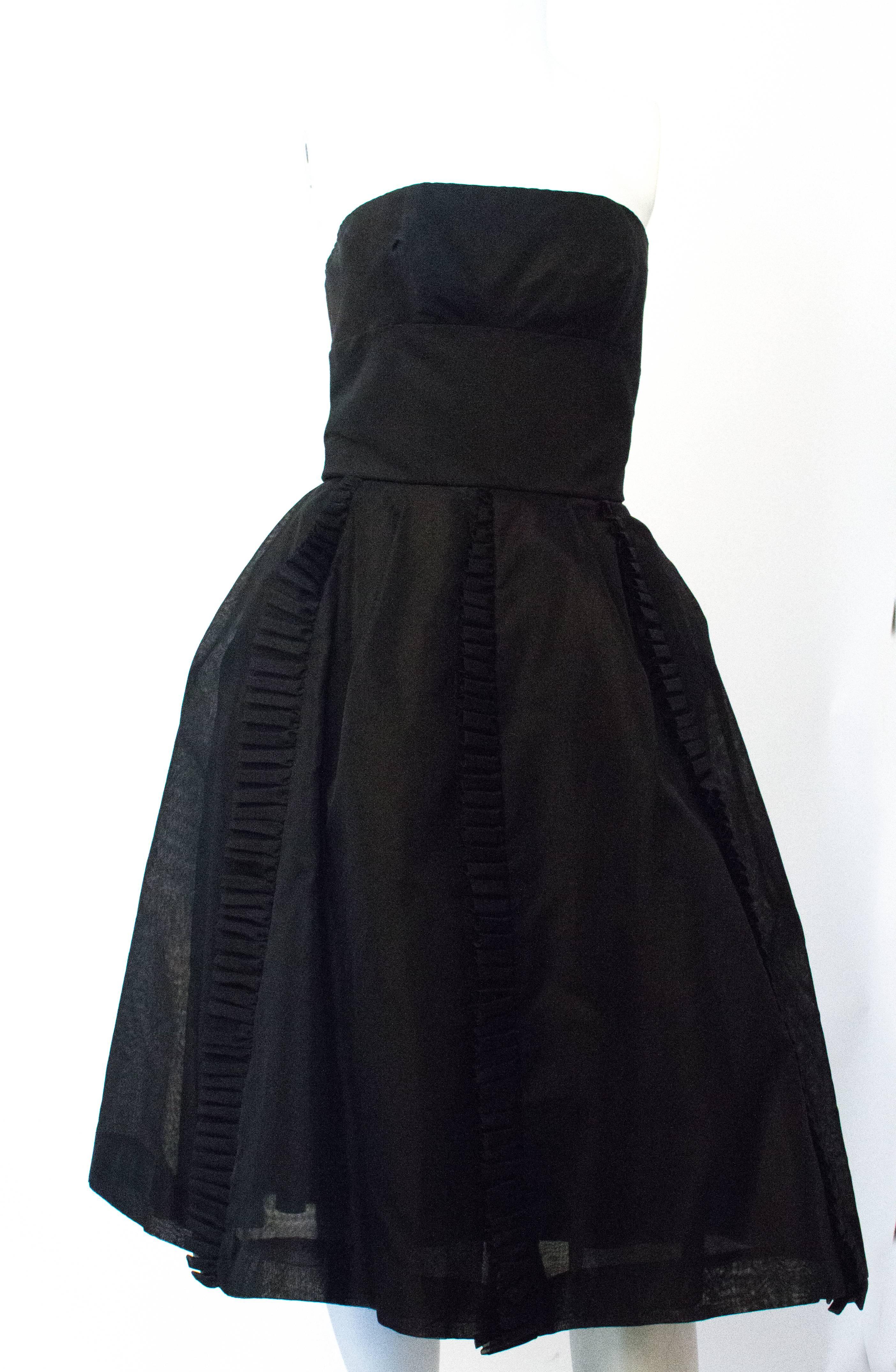 1950's Jeunes Filles dress designed by Jacques Hein for I Magnin & Co. This piece is constructed with a gros grain bodice and is fully lined. The shell is silk organza and features a metal zipper at center back. 

