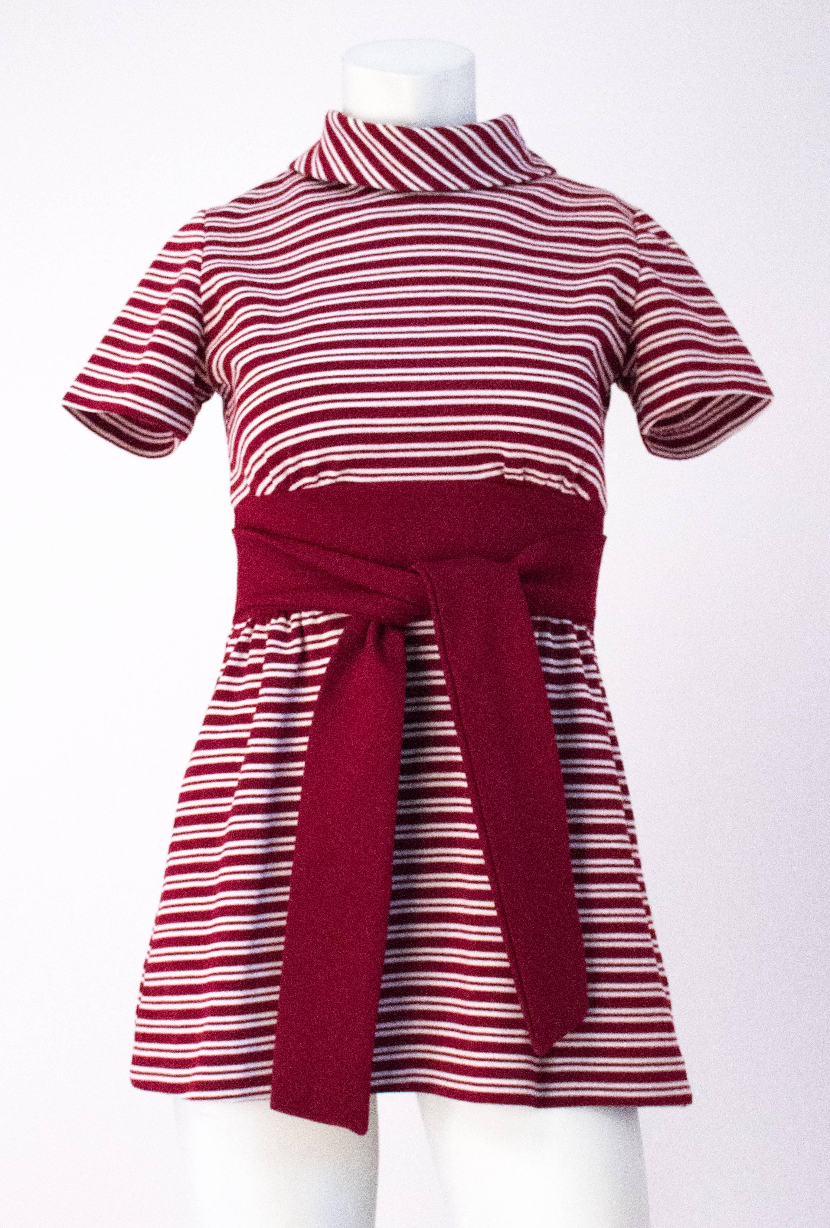 60s Red & White Stripe Mini Dress. 2 inch collar. Attached waist ties. Center back metal zipper. Two hook and eye closures on neck. 