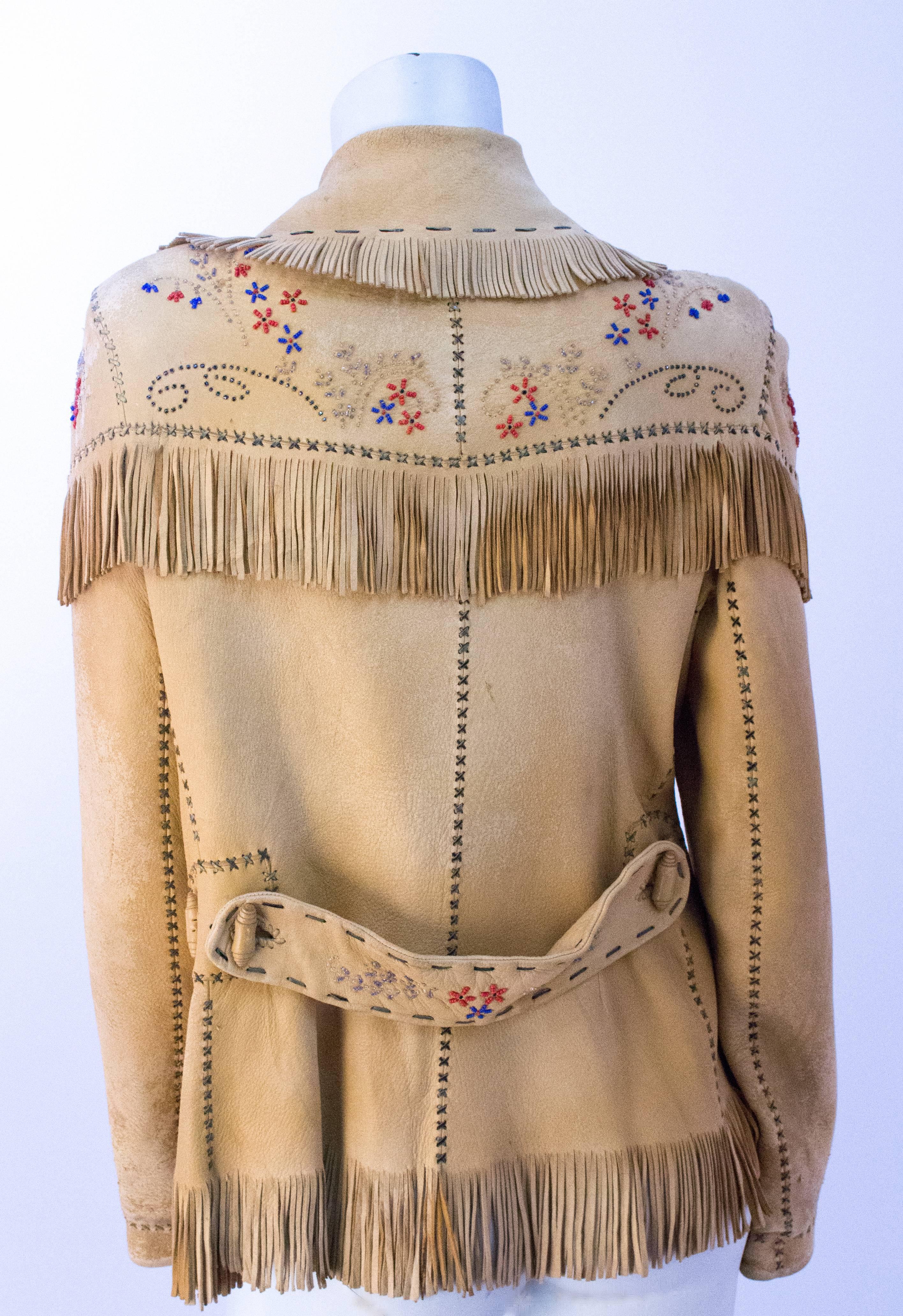 40s Western Beaded Leather Fringed Jacket. Patch pockets. Belt back. Lined in satin. Rolled leather buttons. 