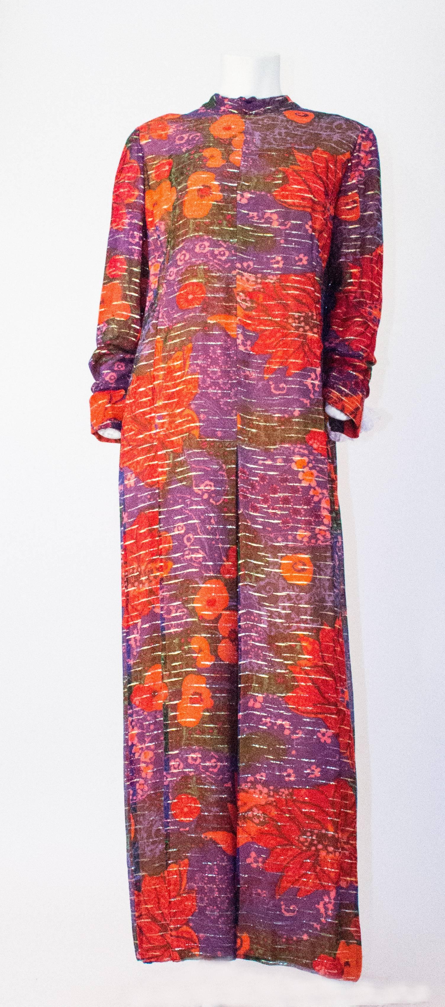 60s Purple & Orange Pauline Trigere Floral Long Sleeve Silk Chiffon Dress. Hand finished. Dress is fully lined but the sleeves are sheer. Nylon zip up the back. Zips at the wrists. 