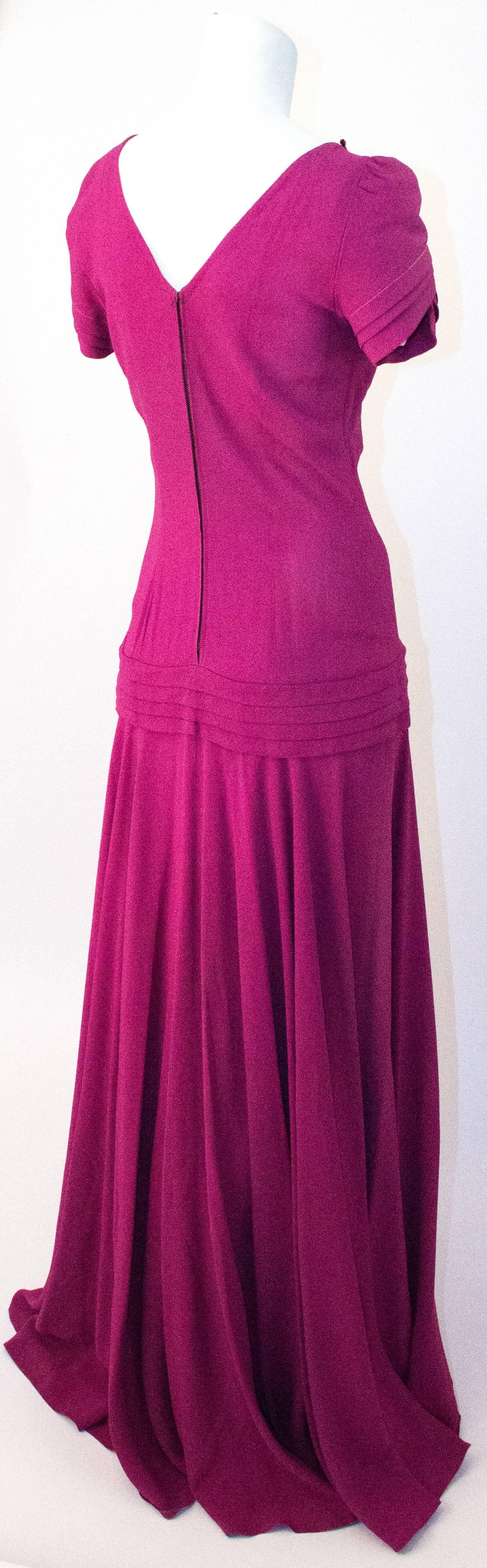 40s Magenta Bias Cut Crepe Gown with Sequined Appliqué. Gold and magenta sequined embellishments along bust-line and front of hip. Slight shoulder pads. Cap sleeves. Fitted bodice. Unlined. 

