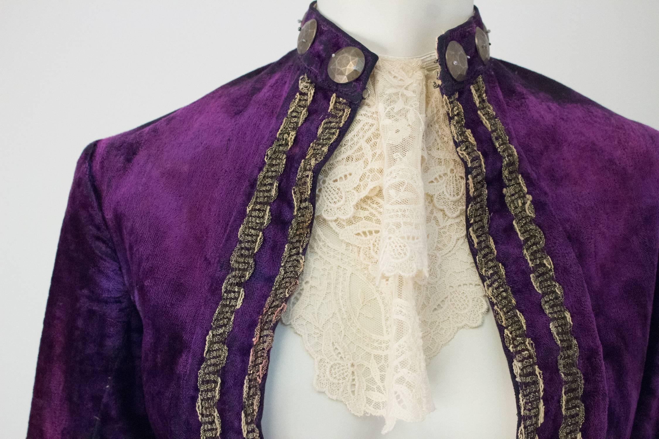Edwardian Purple Velvet Louis XIV Pirate Prince Jacket with Jabot. Silver metallic trim throughout. Silver toned button adornments. Front mock flap pockets. Jabot included (made recently). Velvet fabric appears to be faced in a cotton fabric.