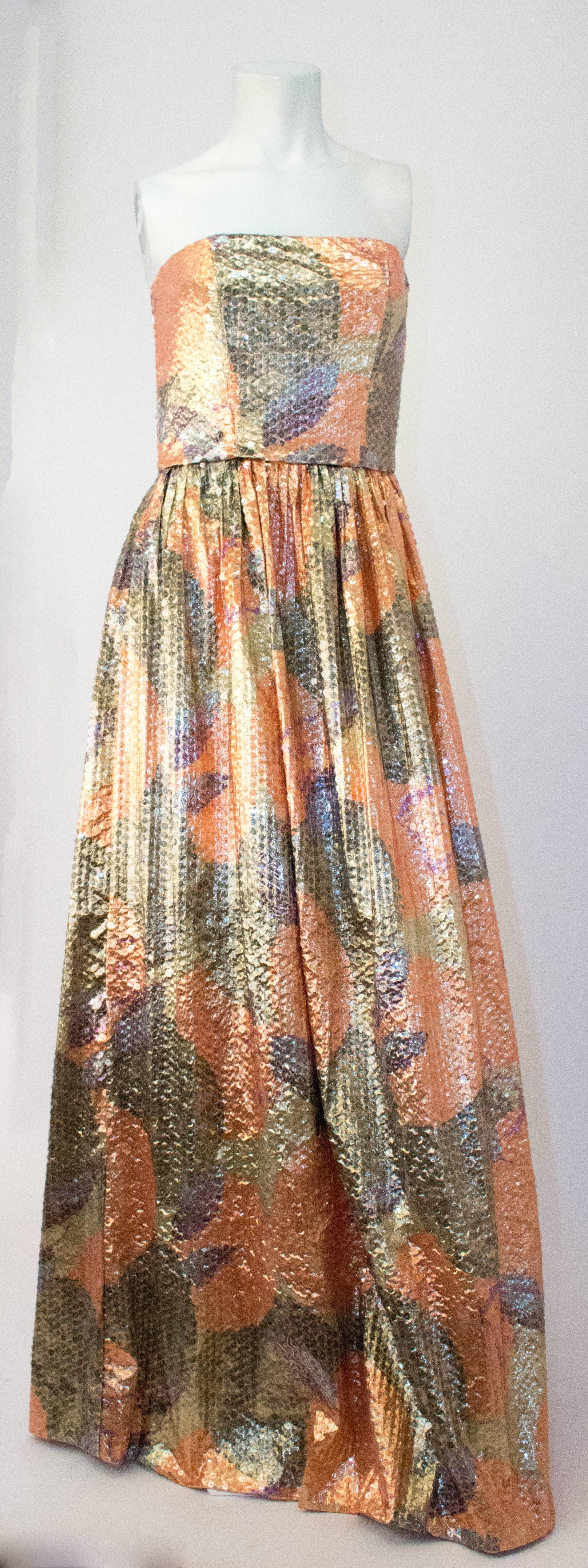 60s Peach & Silver Strapless Sequined Gown. Gathered skirt. Lined bodice. Boning in bodice. Unlined skirt. Zips up the side. 

