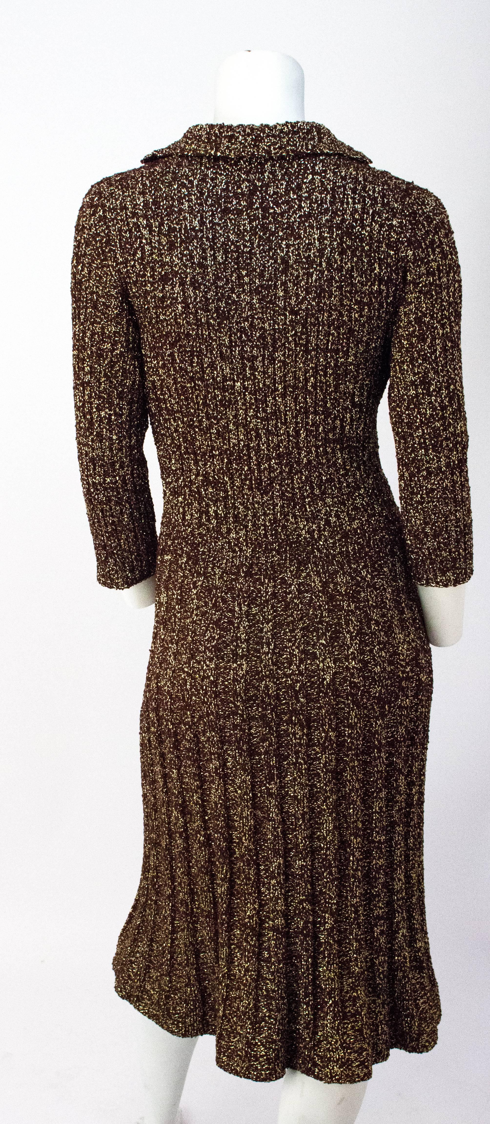 40s Brown & Gold Knit Sweater Dress. Metallic gold thread woven throughout. Buttons up the front with matching covered buttons. Unlined. 

