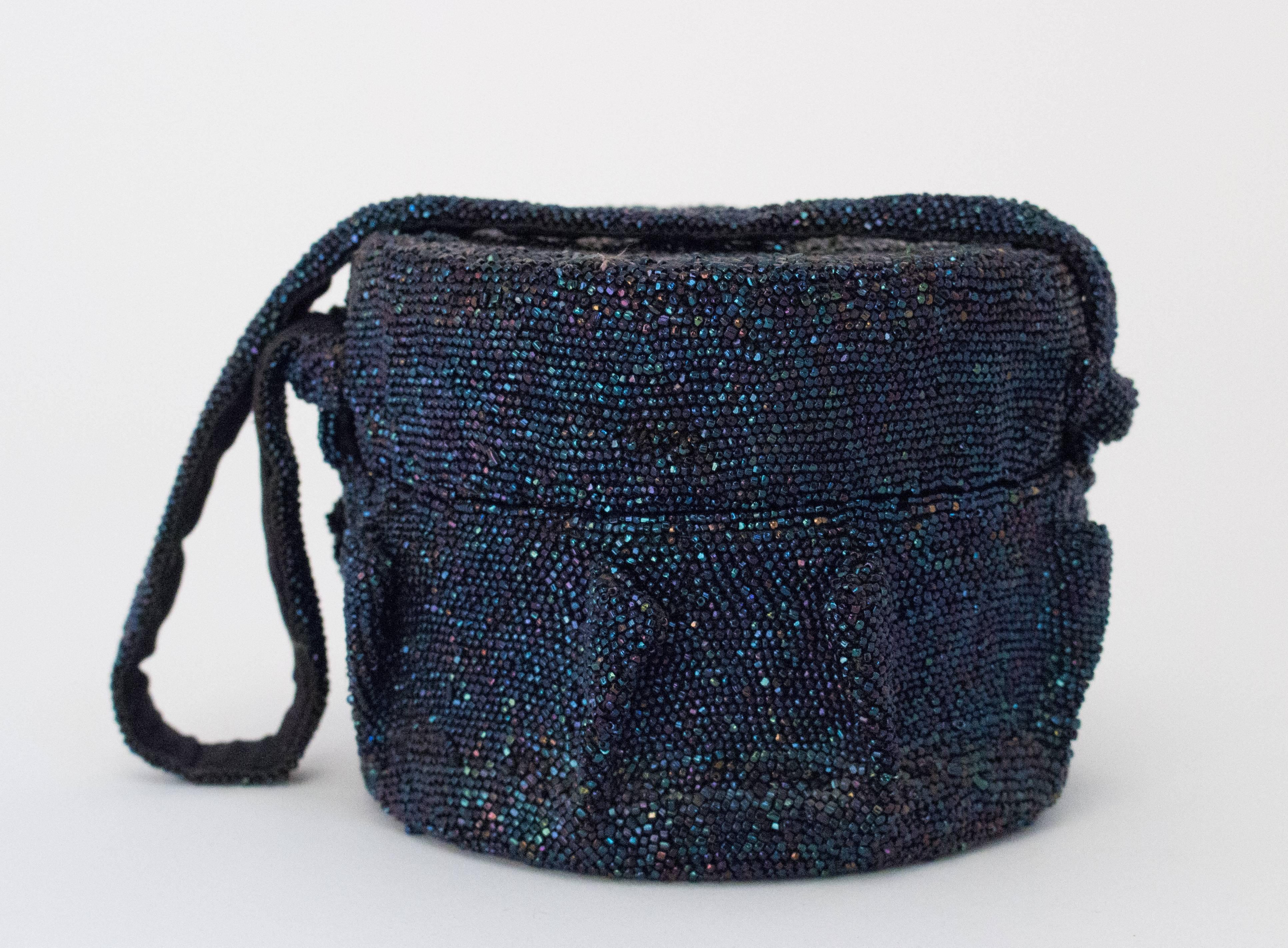 40s Blue Iridescent Round Beaded Handbag. Lined. 

Measurements:
Height: 4 1/2 inches
Circumference: 19 inches 
Strap: 18 1/2 inches 