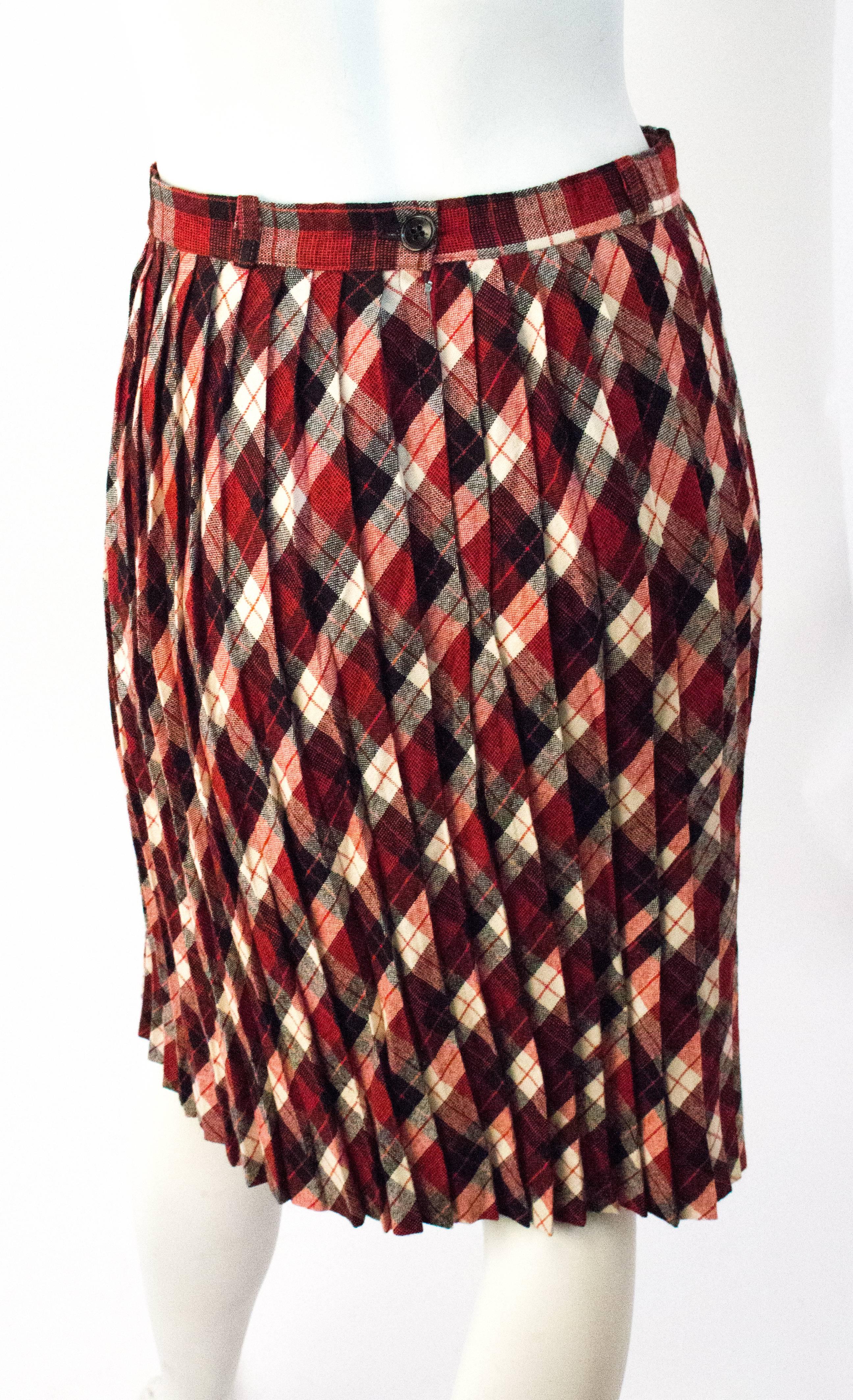60s Red, Black & Cream Plaid Pleated Skirt. Unlined. Metal zipper up the side. Buttons at the waist. 