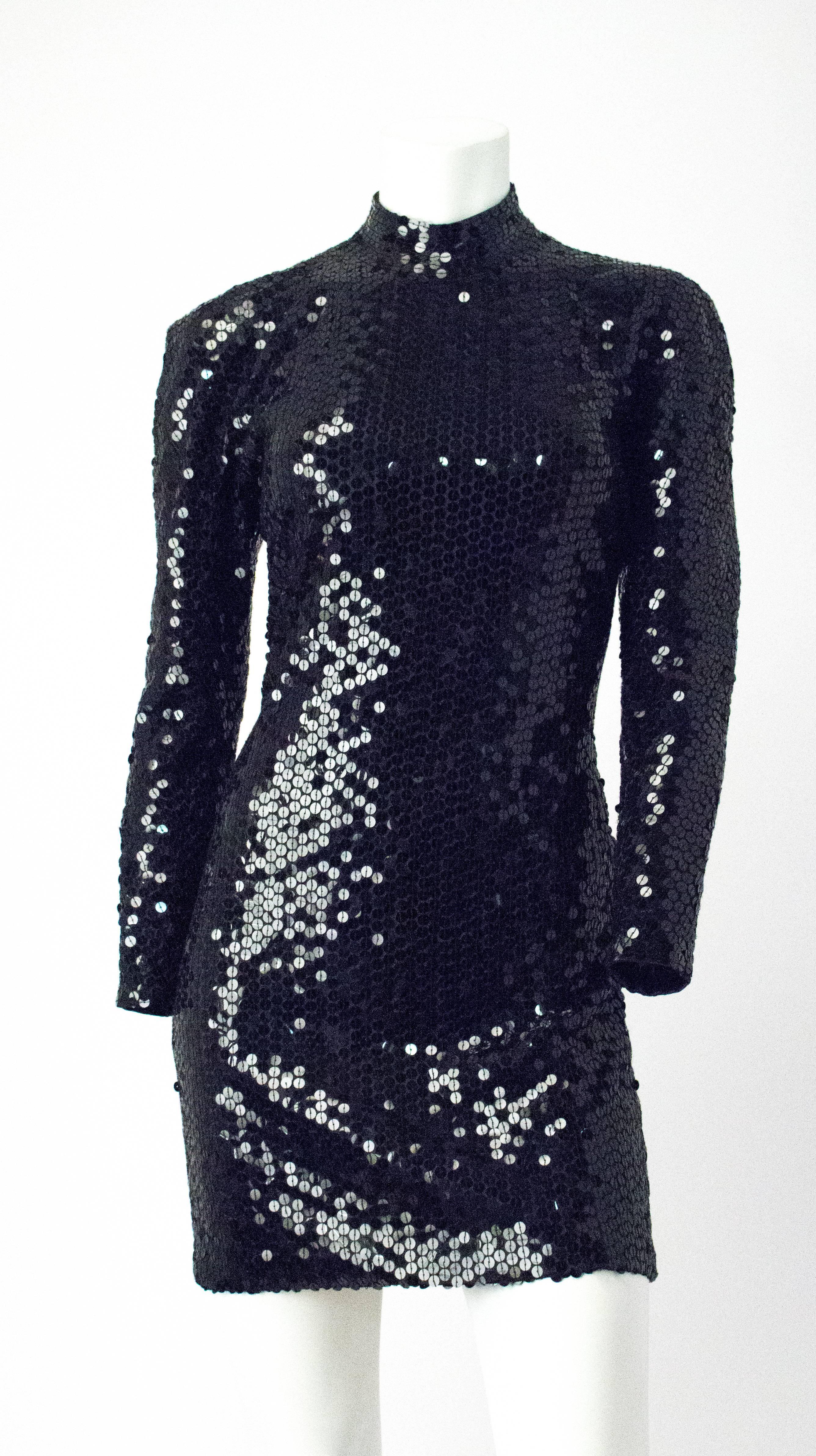80s Oleg Cassini Black Sequin Cocktail Dress. Contour fitting, long sleeve with a high collar and open back. There is a center back zipper closure.

