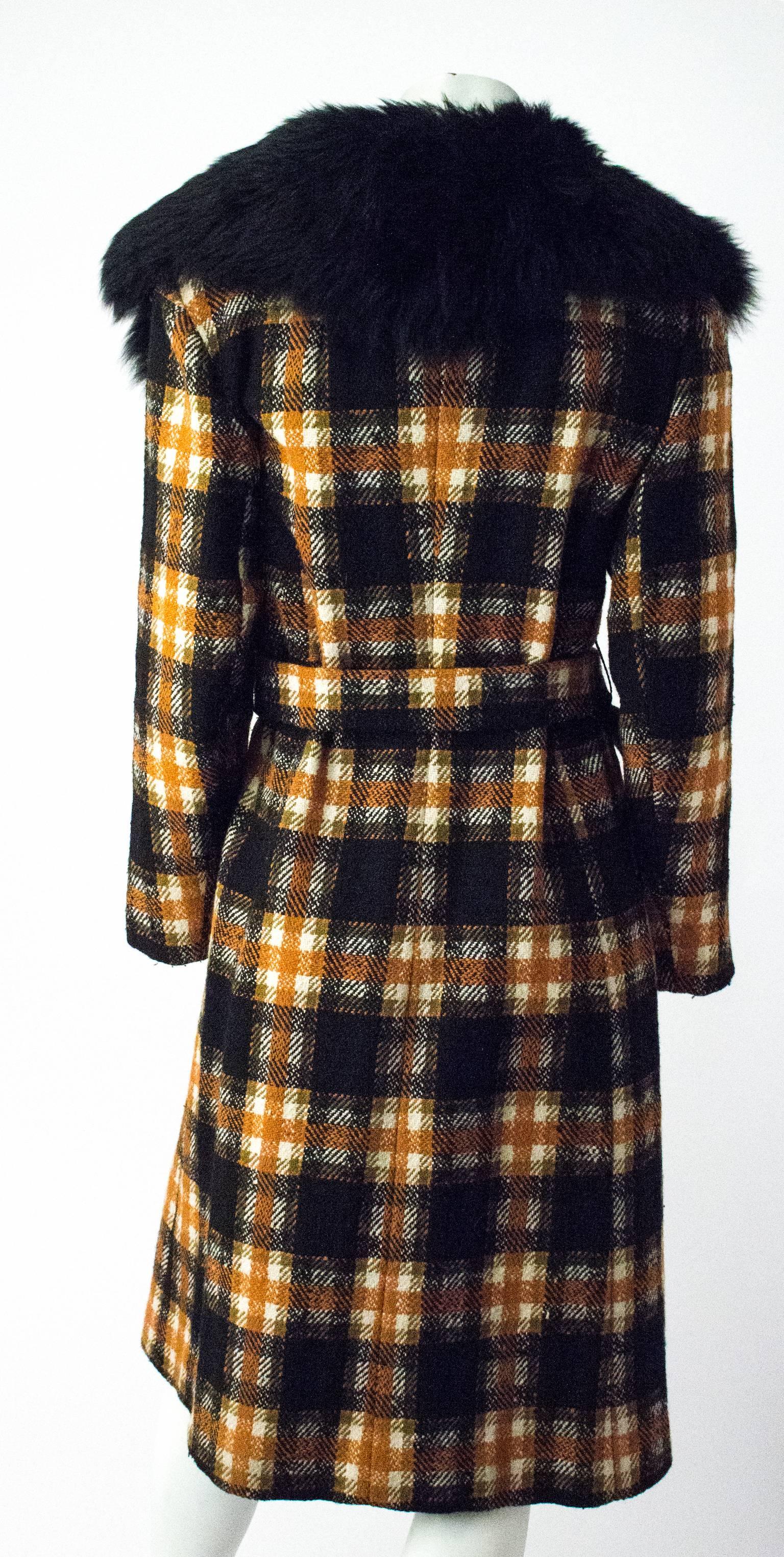 1970s orange and black plaid wool coat. Faux fur collar. Inseam front pockets.