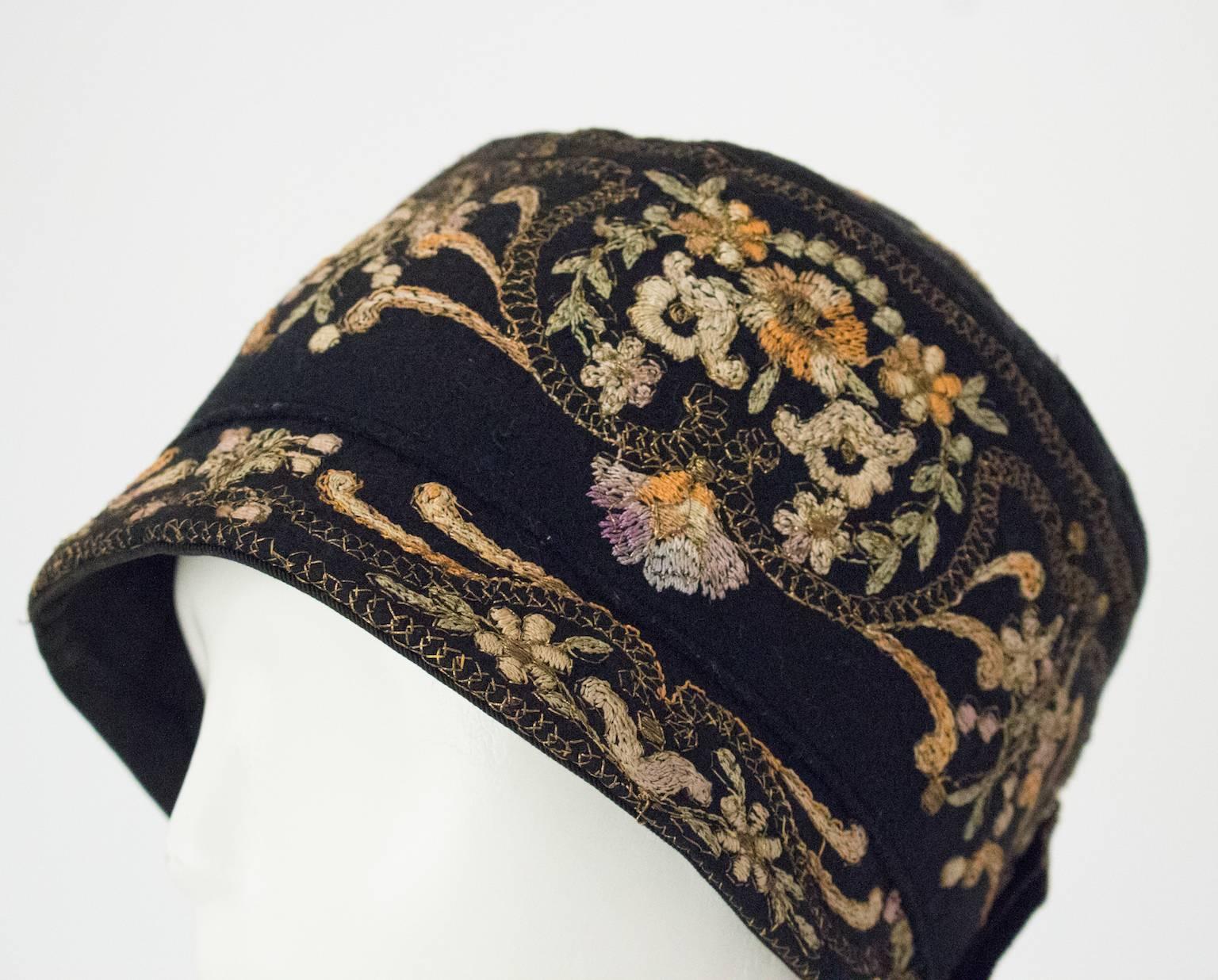 1920s black cloche with gold and silk embroidery. Wool felt. 21" circumference.