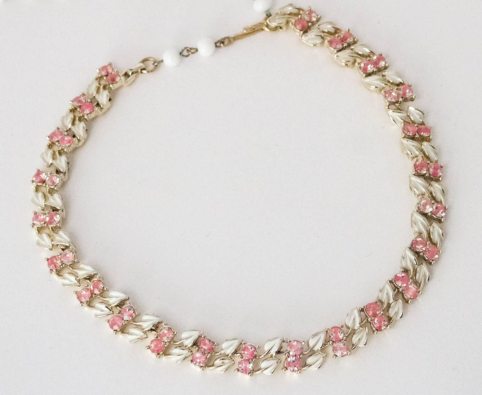 1950s Coro pink rhinestone and white leaf enamel gold toned choker-length necklace. Adjustable. Full length 17 1/2