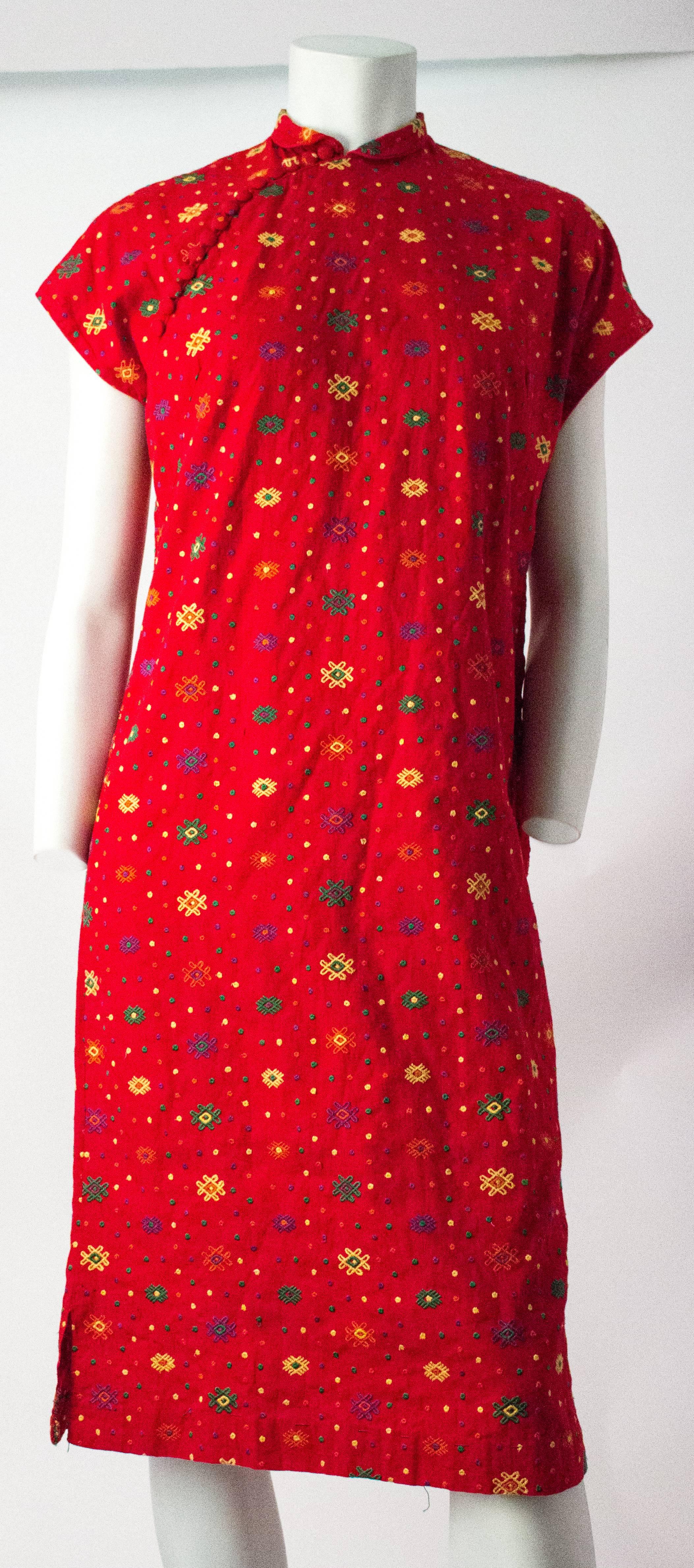 60s Red Embroidered I.Magnin Cheongsam Dress. Metal zipper up the side. Covered buttons unfasten along the top side. 