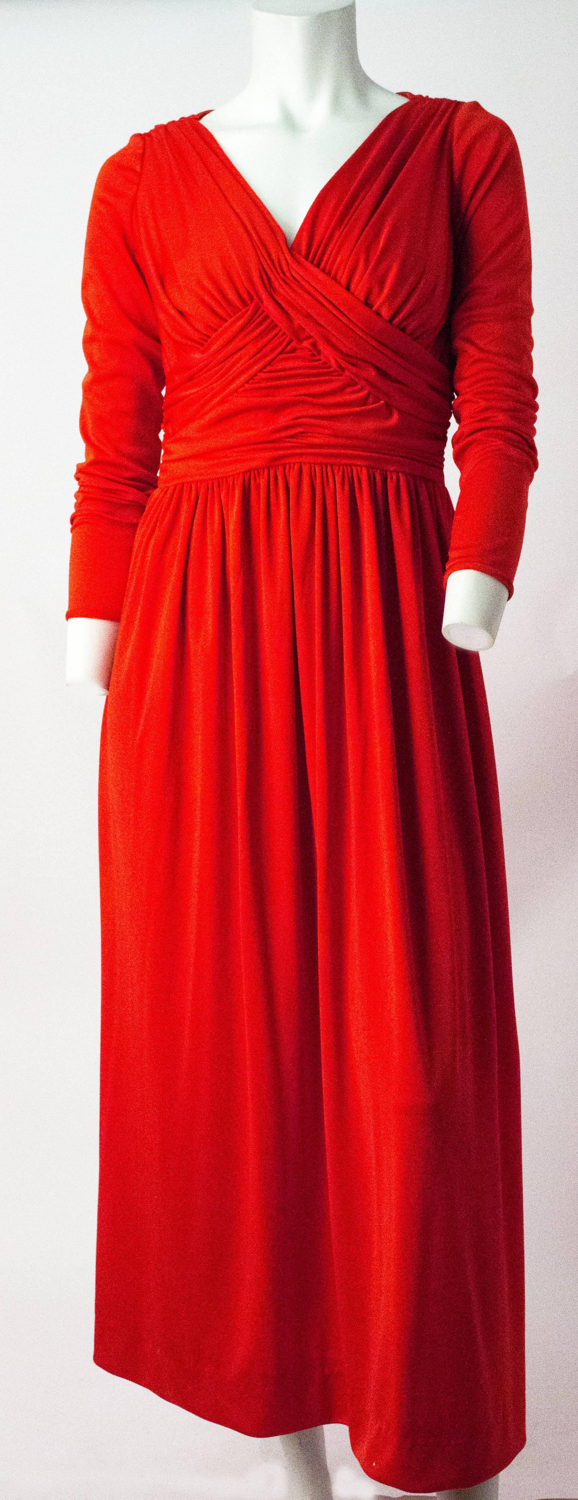 70s Red Silk Jersey Long Sleeve Ruched Bodice Maxi Dress. Lined bodice. Zips up the back. 