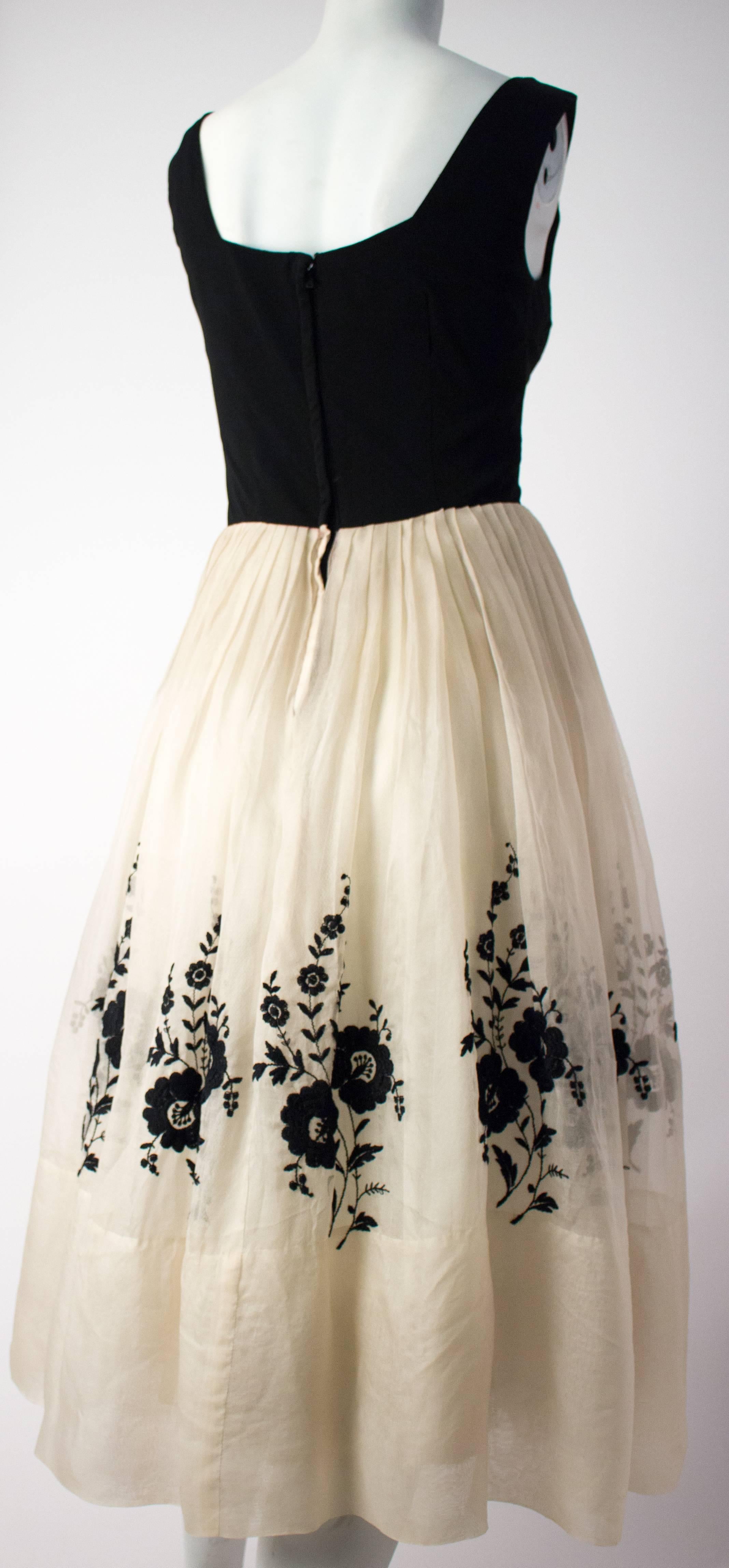 50s Audrey Dress. Silk organza skirt with black embroidered flowers, lined in tulle and satin. Bodice is silk jersey, lined with satin. Metal back zip closure.