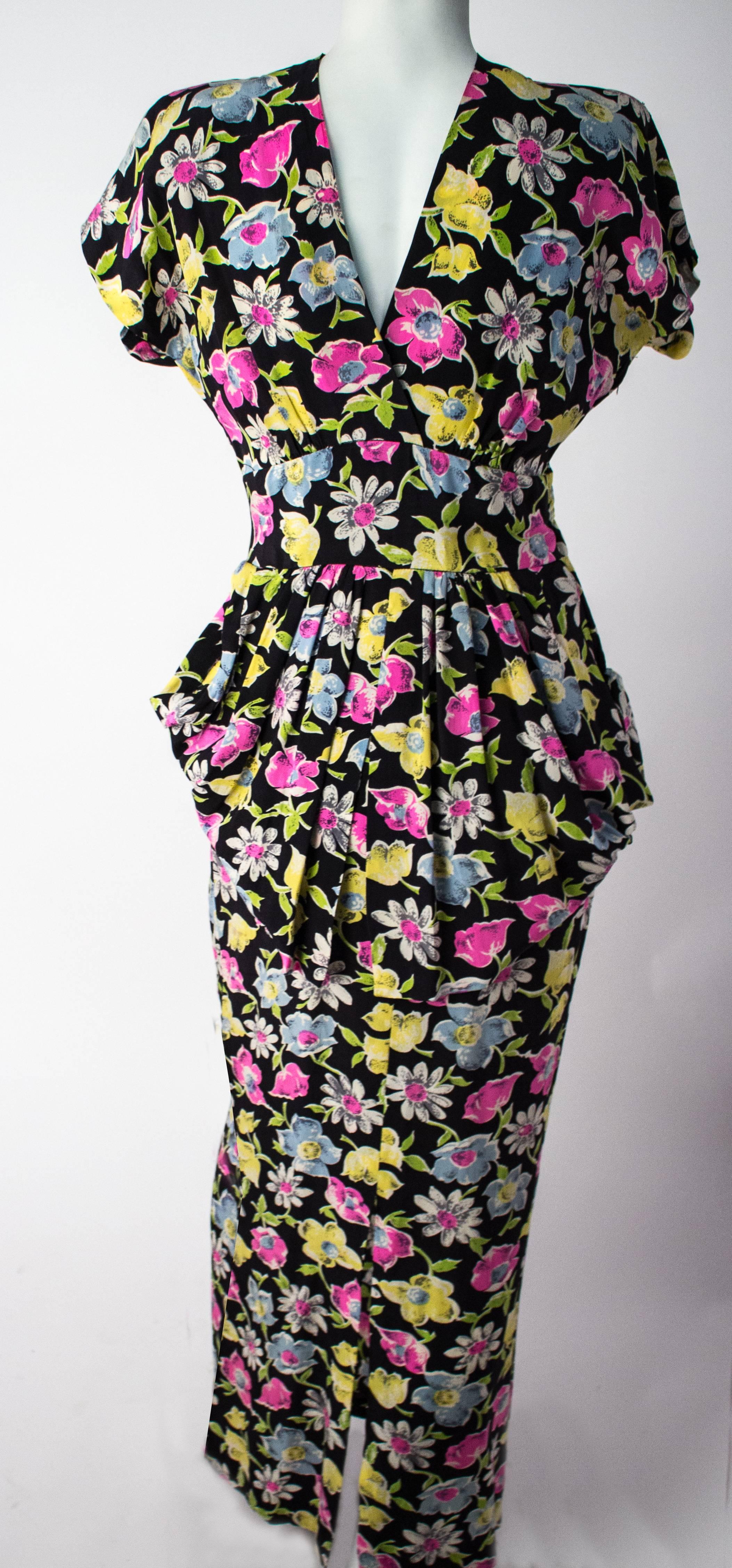 40s Floral Printed Silk Peplum Dress. Metal side zip closure. This manniquin is styled with the dress worn backwards, it can be worn either way for more versatility. 