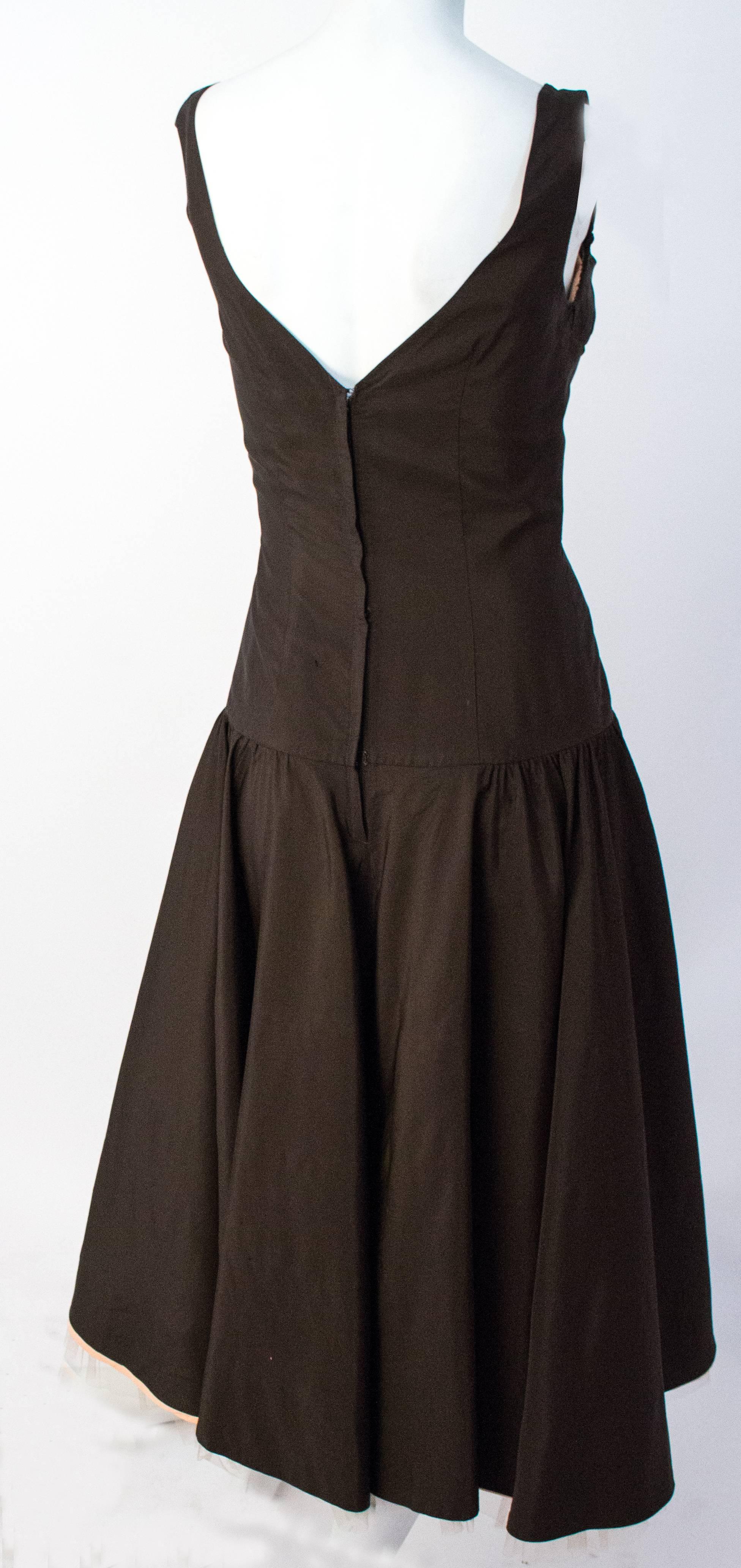 50s Chocolate Brown Party Dress with Pale Pink Tulle Ruffle Detail. Unlined. This dress is wearable but has some very small holes in the back of the skirt.
