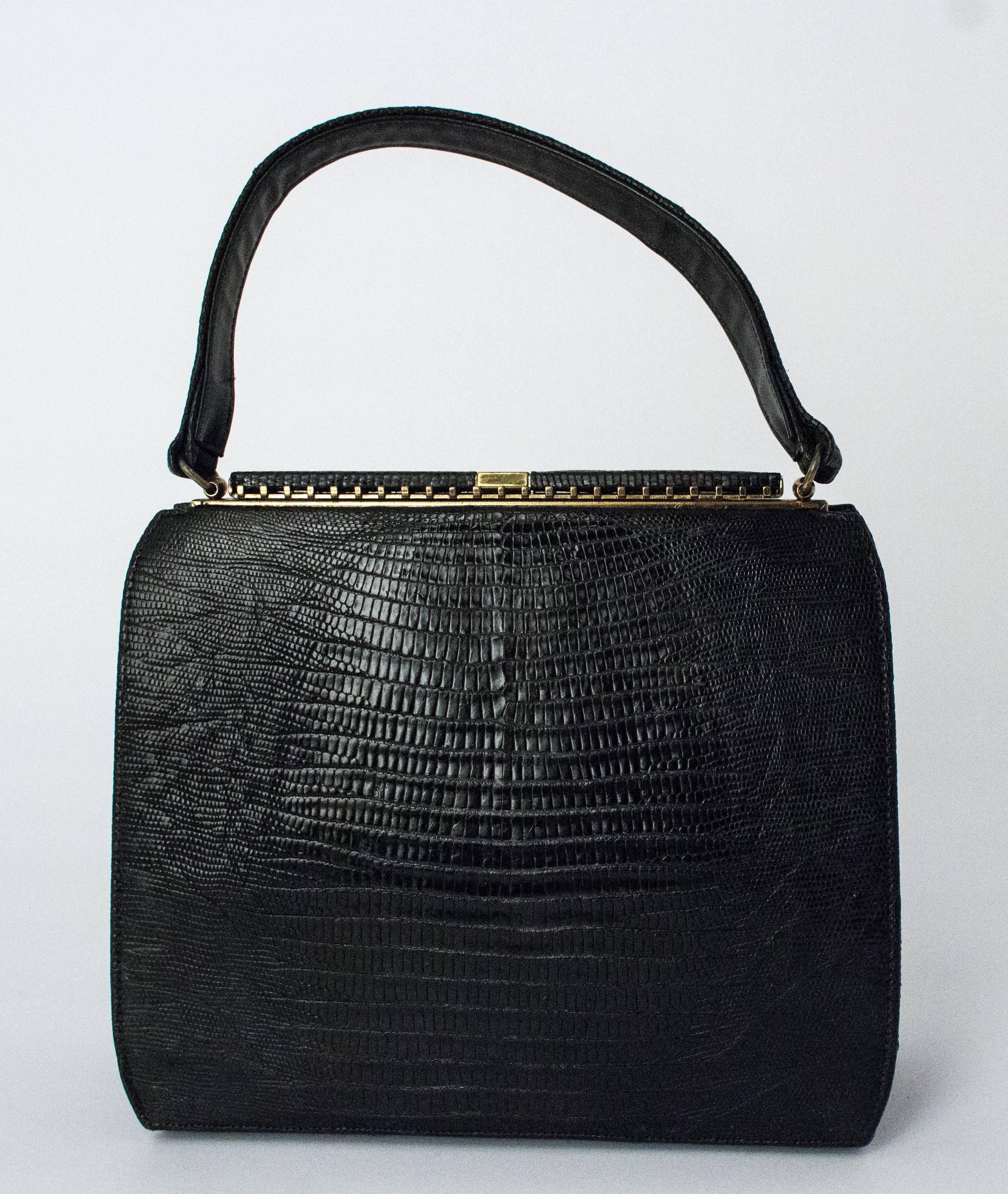 50s Roos Atkins Black Lizard Handbag. Comes with original mirror (slight tarnish), coin purse, and comb. Leather interior.