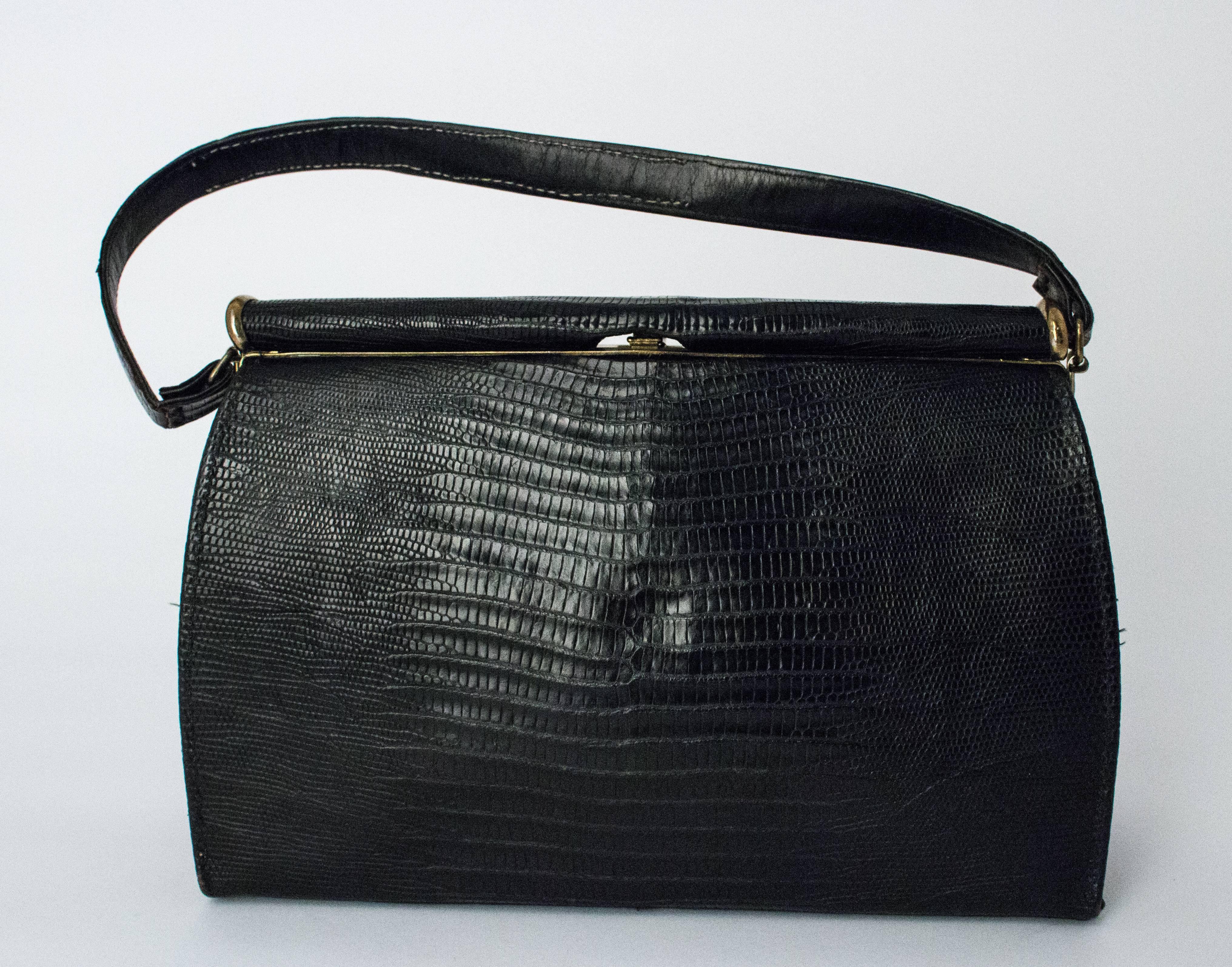 50s Black Lizard Handbag. Leather interior, one side pocket, lizard covered outside hardware. Comes with original mirror. 