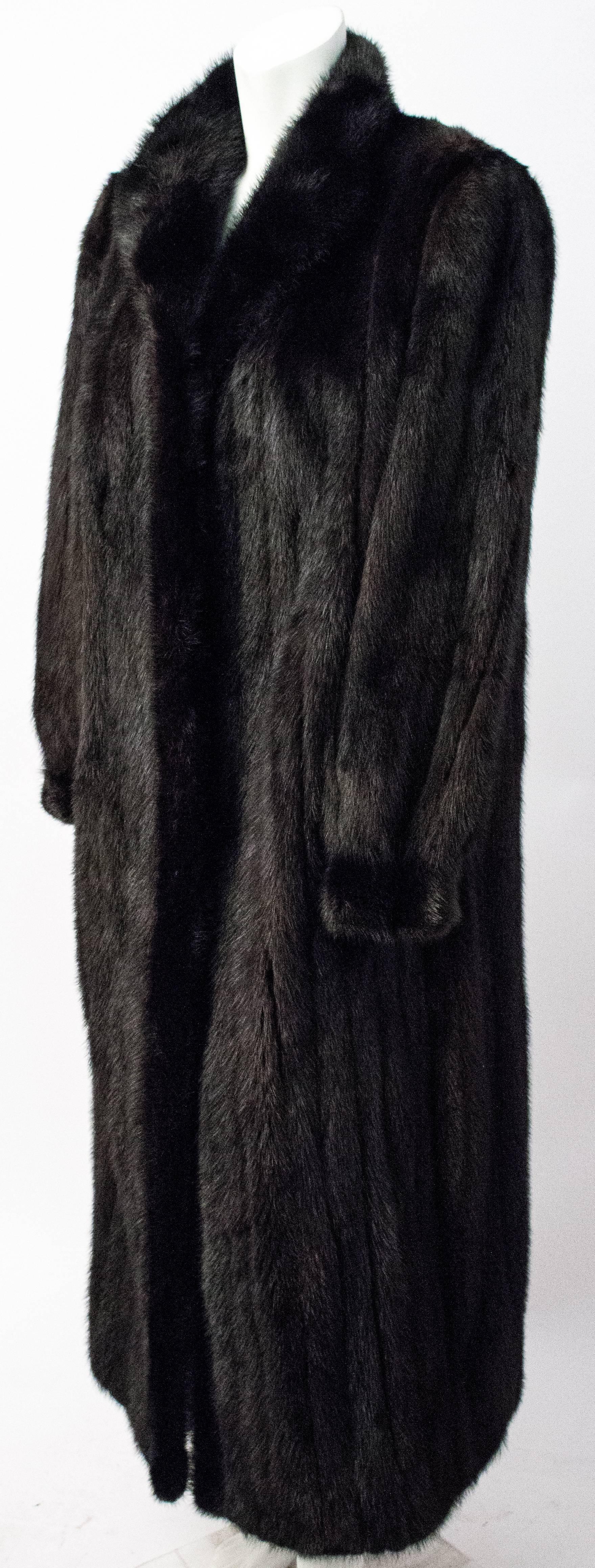 90s Exquisite Black Full Length Ranch Mink Coat. Marked size US women's 7, will fit anywhere between size 6-10. Two front pockets, lined in velvet. Front snap fur closures.