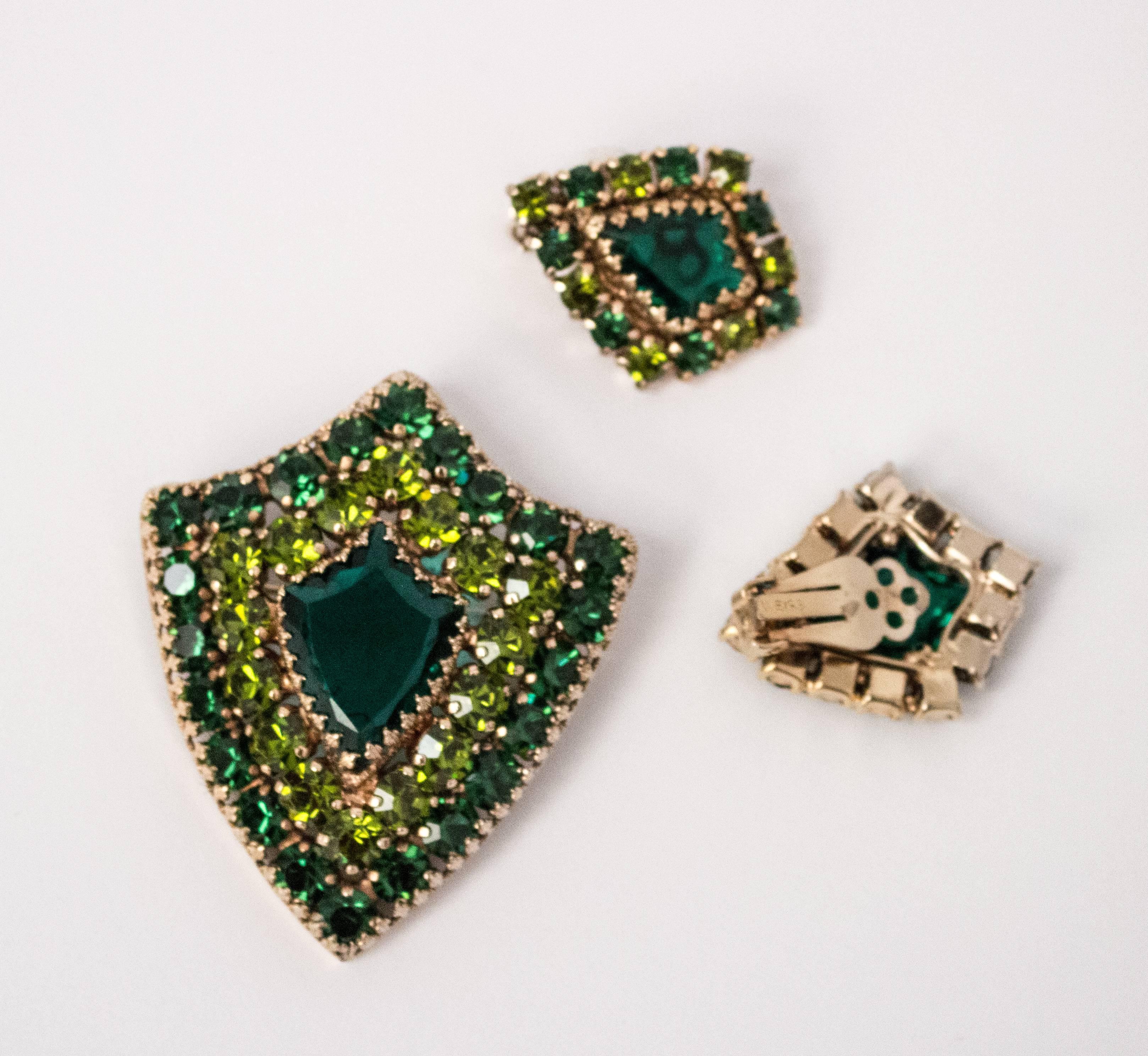 60s Weiss Green Rhinestone Brooch & Earring Shield Set. Signed. Clip-on earrings.  

Brooch:
2" long
2 1/8"  wide

Earrings:
1 1/2" long
1 1/8" wide