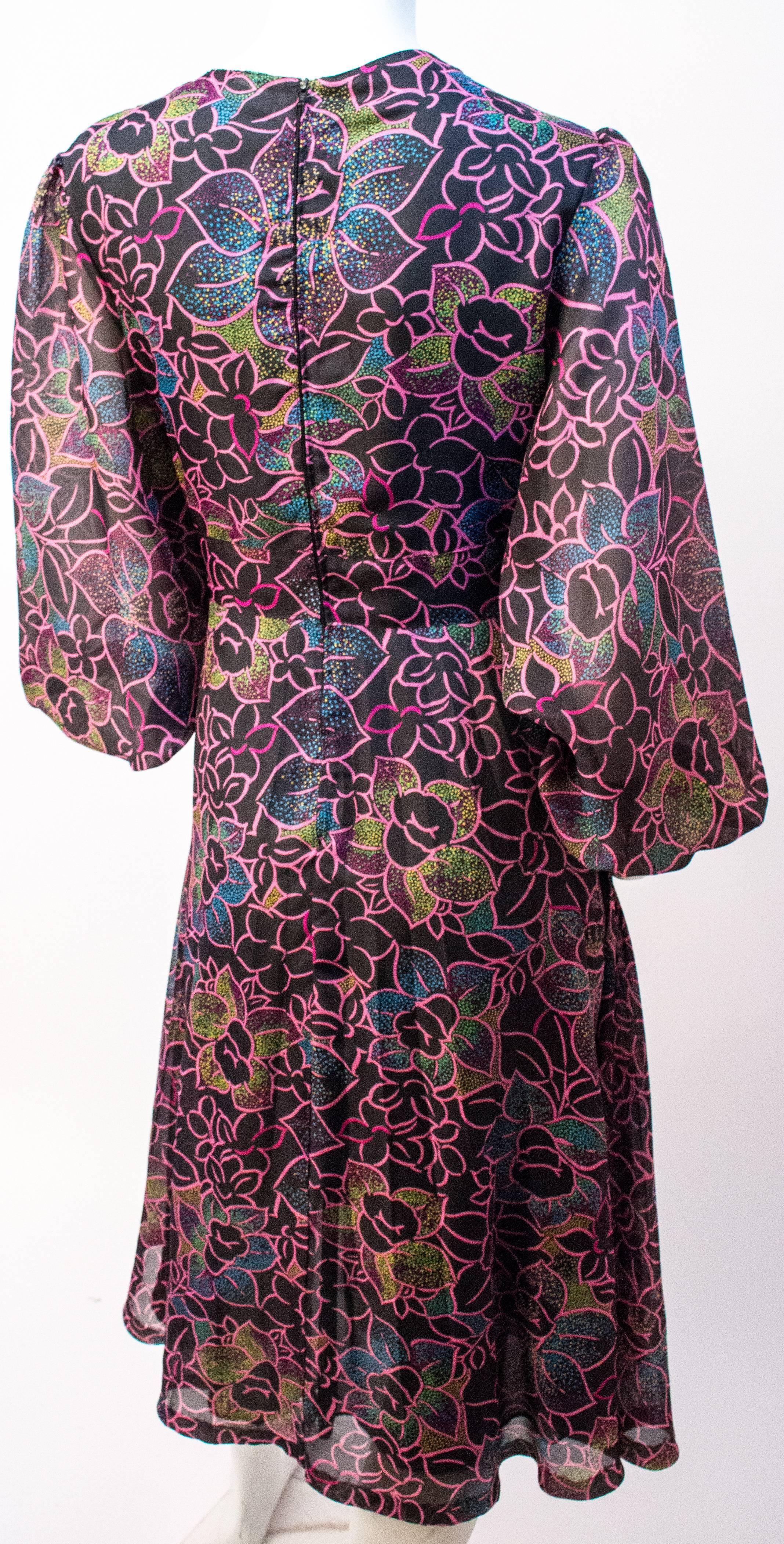 70s Floral Printed Chiffon Dress. Lined in synthetic black mesh. Back zip closure. 