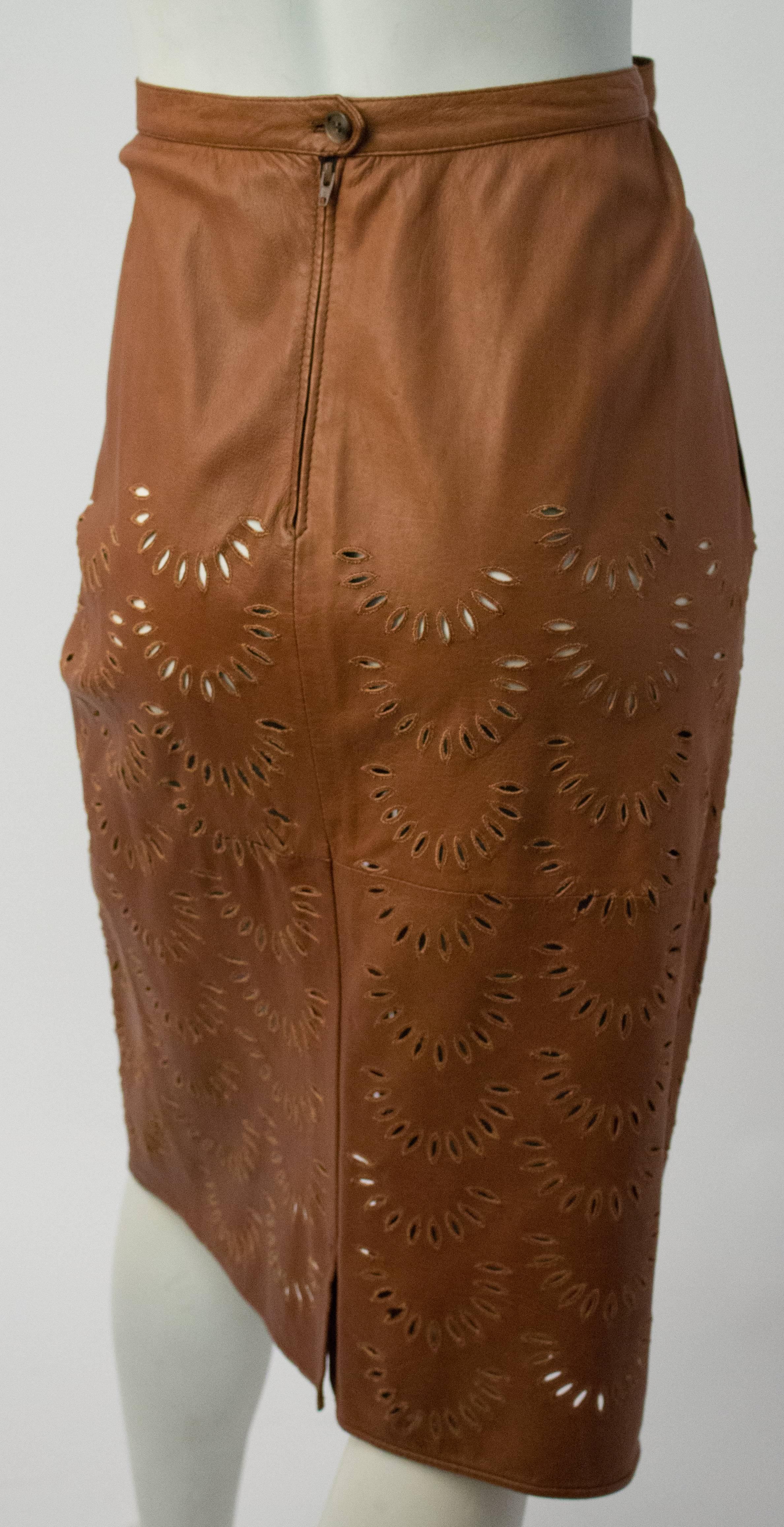 Valentino Calfskin Leather Skirt w/ Cut Work Detail. Two side pockets. Unlined, cotton faced waistband. Back seam zipper and button closure. Petal-shaped cutouts reinforced with stitching. Size EU 48. Made in Italy.