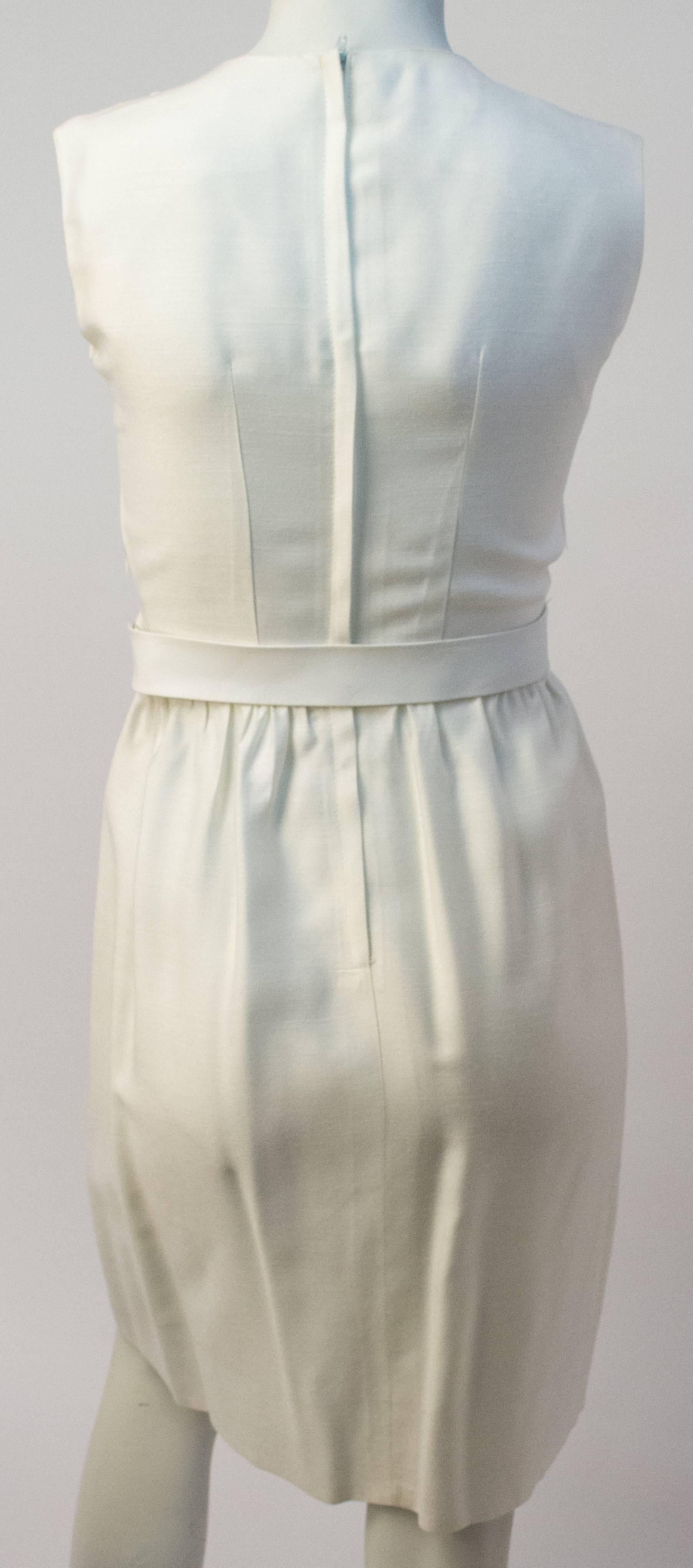 50s White Sheath Dress with original white belt. Princess seaming. Slightly gathered at waist. Lightweight fabric. 

The measurements are as follows;

Bust: 34 inches
Waist: 25 inches
Hip: up to 38 inches
Length: 37 1/2 inches

It is about a US size