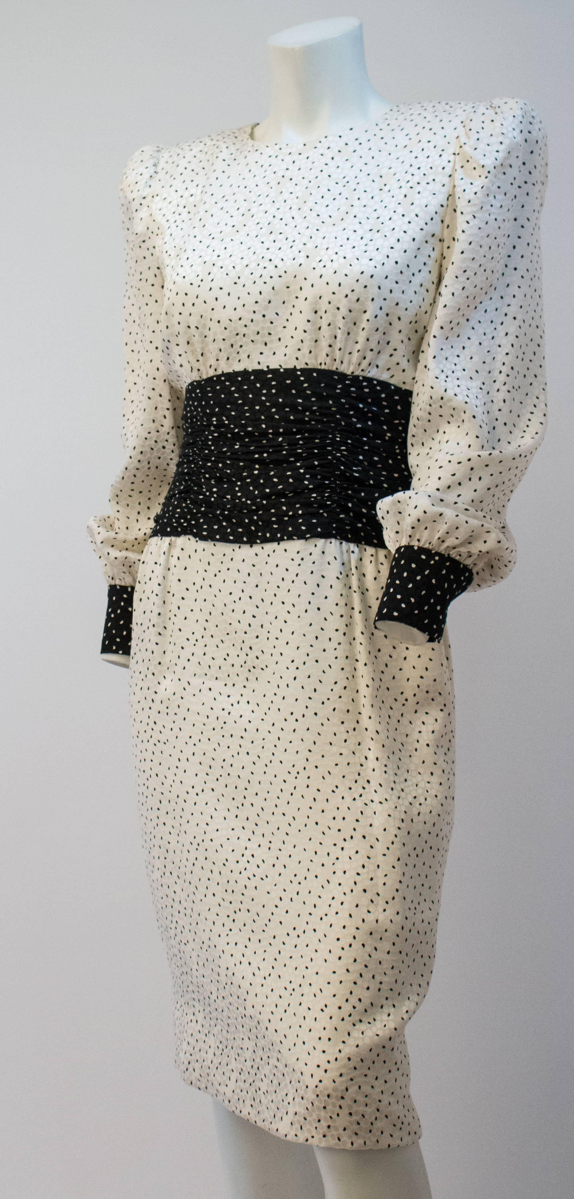 80s Carolina Herrera Dot Dress. Back zipper closure. Fully lined. Snap wrist closures. 