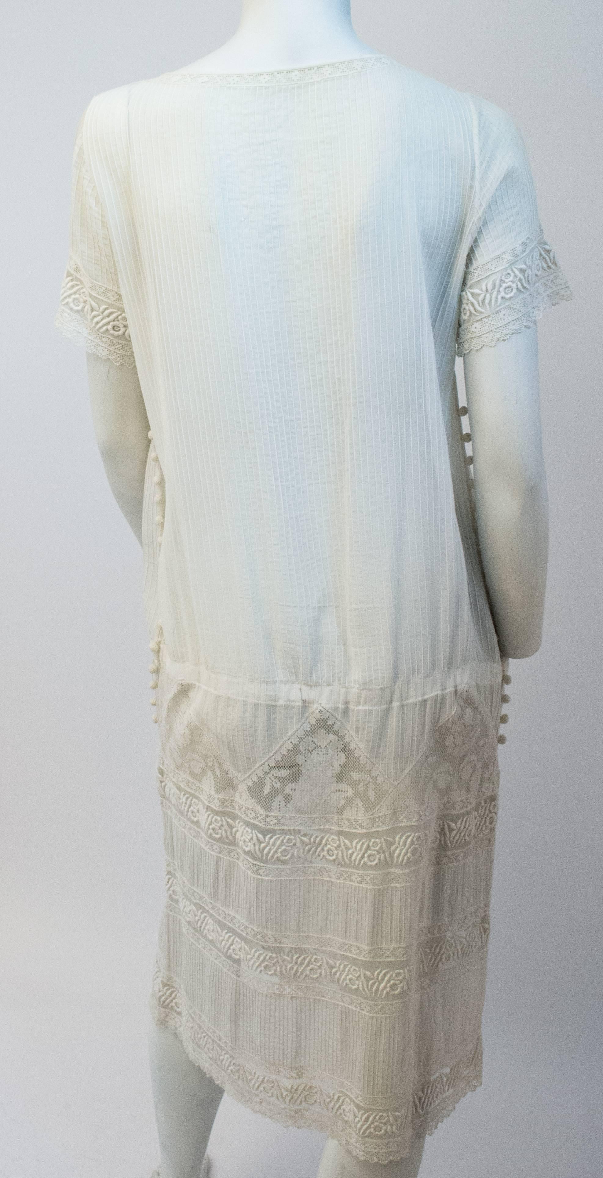 20s White Cotton Day Dress w/ Pintucks. Embroidered and crocheted lace. Decorative side crocheted baubles. No closures.