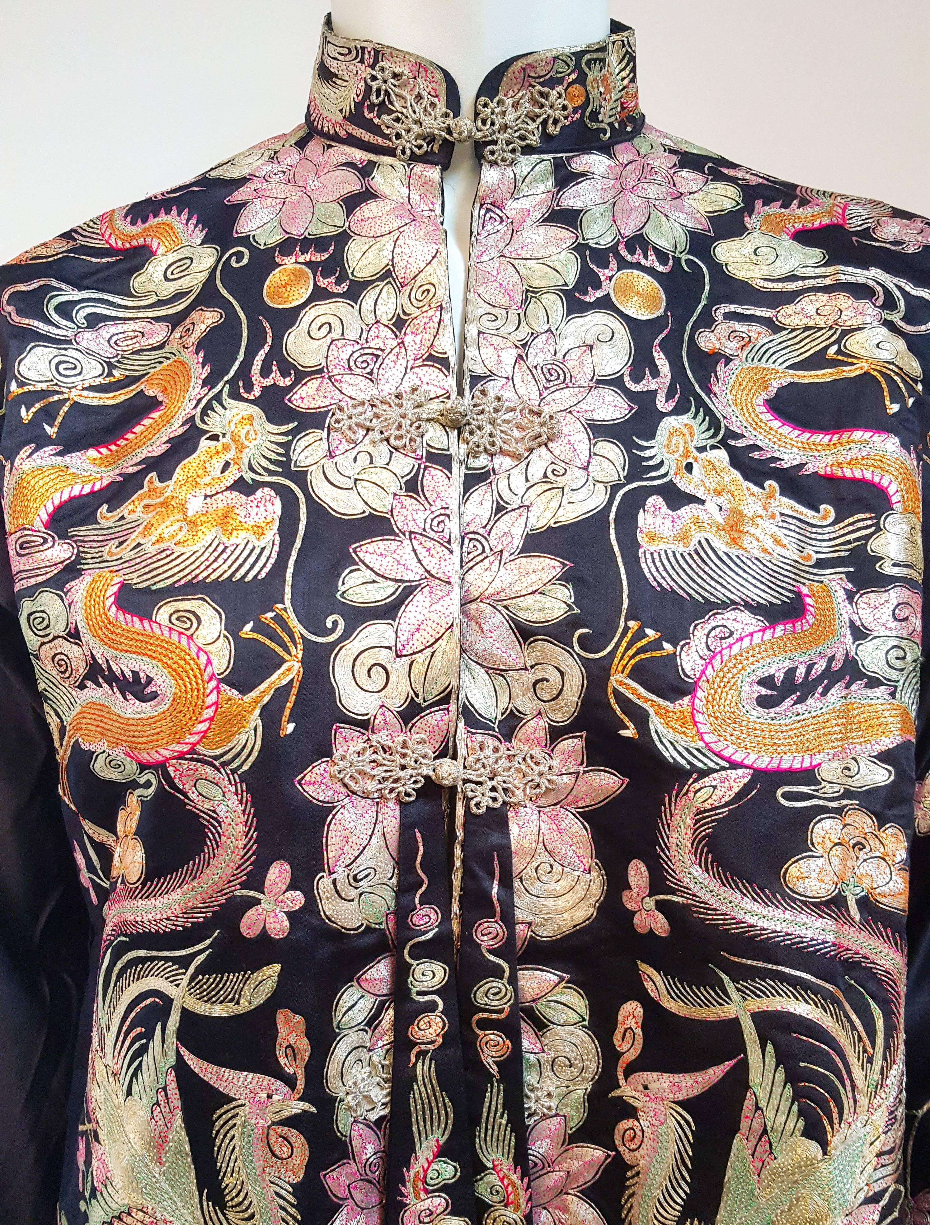1950s Chinese Silk Top w/ Silver Metallic Embroidery. Dragon and Phoenix motif. Frog clasps down center front. Dolman sleeves. Lined in pink silk. 