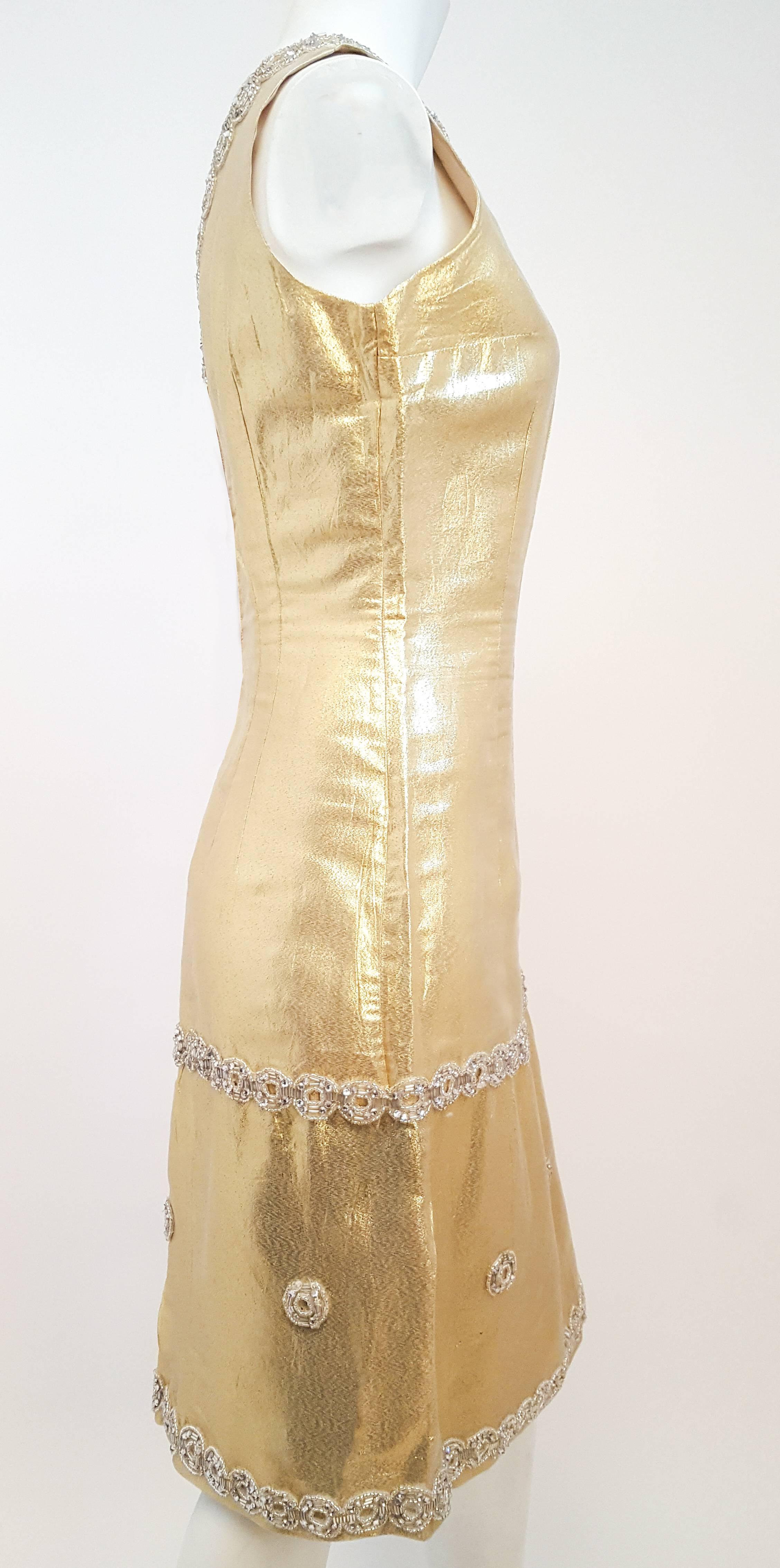 1960s Gold Lamé Cocktail Dress w/ Silver Beading. Glass bead and rhinestone embellishment. Fully lined and faced. Back zipper closure.