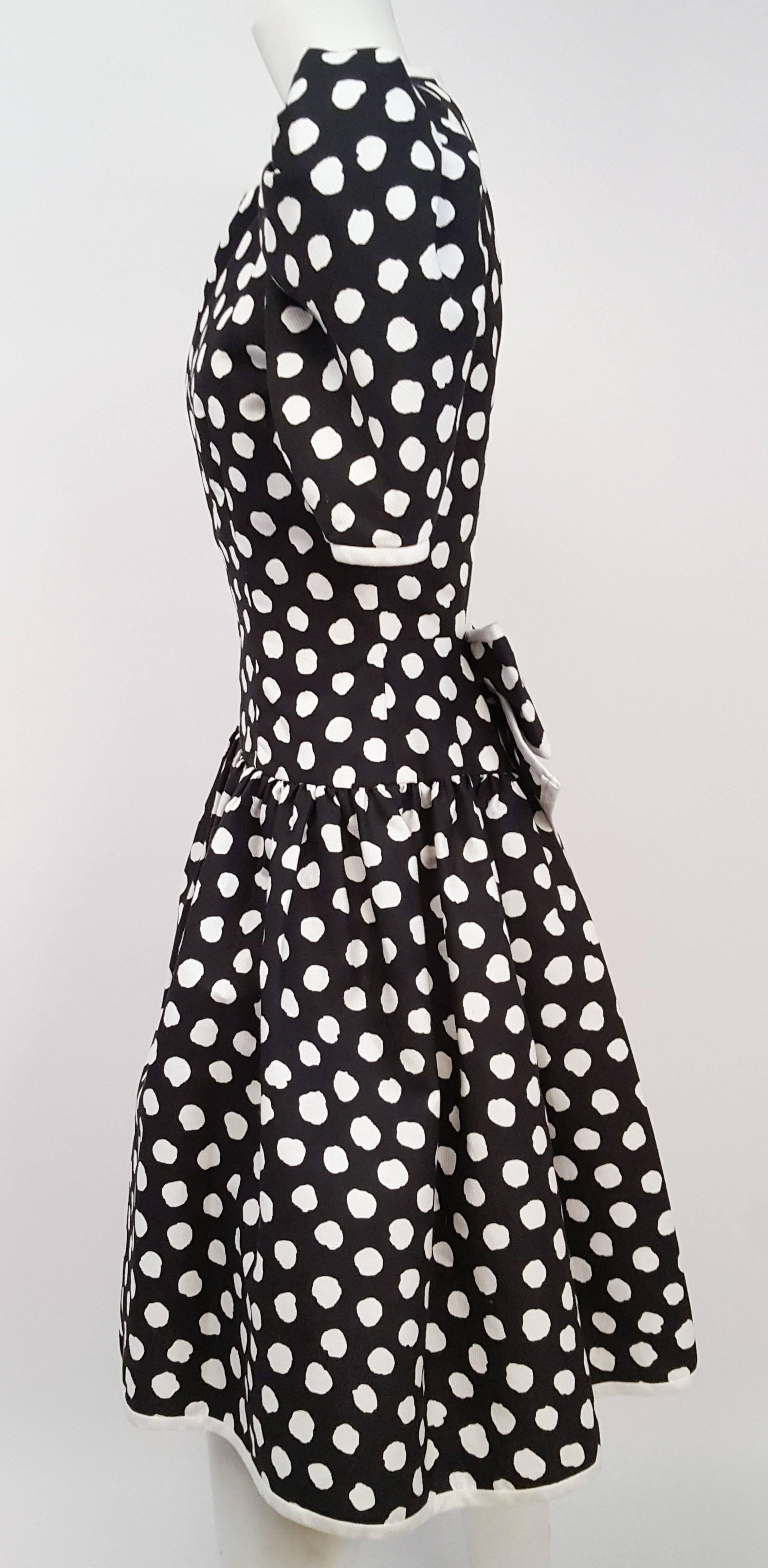 1980s Black & White Polka Dot Party Dress. Open back closes with snaps. Giant back bow detail. Shoulder puffs and skirt have built-in tulle for support. 