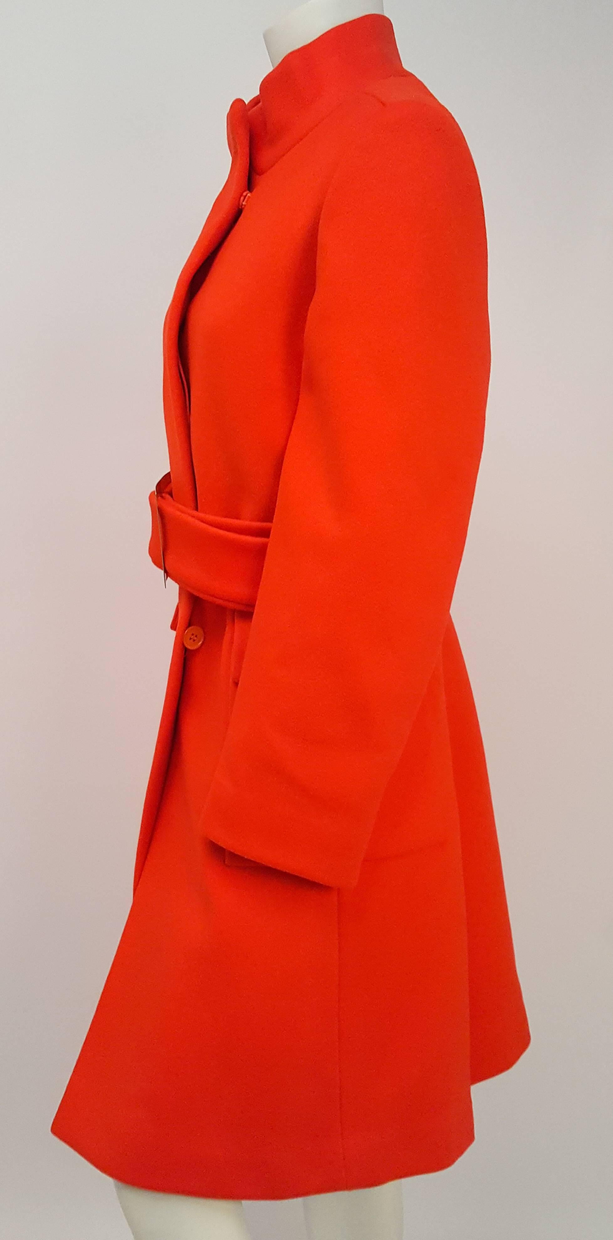Calvin Klein 1970s Red Orange Coat w/ Belt. Hidden placket button and snap front closure. Front pockets. Fully lined. Aprox US Women's size 6-8.