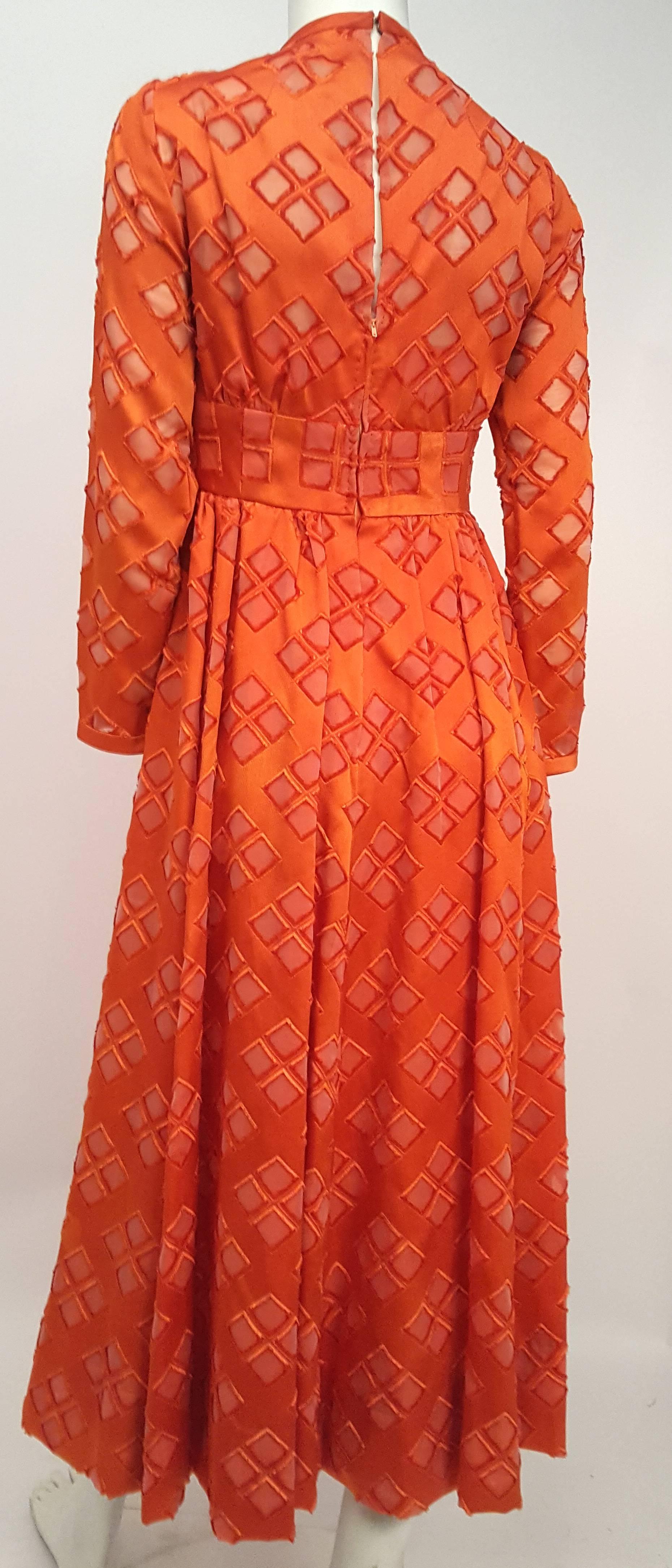 70s Malcolm Starr Orange Cutout Illusion Mesh Dress. Outer layer consists of orange jersey with diamond cutouts over nude illusion mesh, with sweetheart neckline bodice lining. Back zip closure and hook and eye closure.